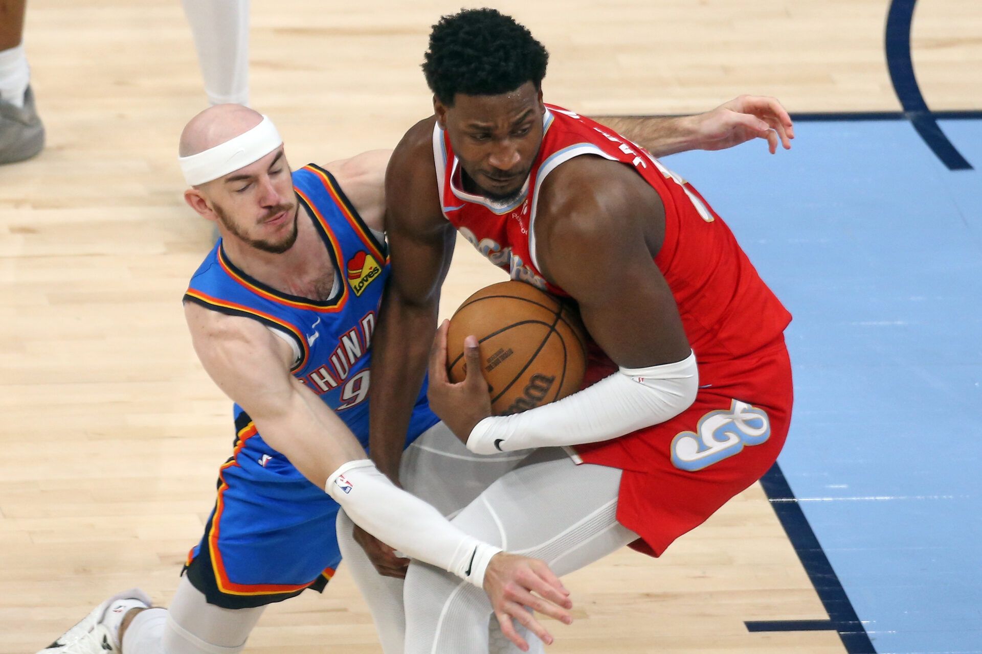 Memphis Grizzlies forward Jaren Jackson Jr. (13) spins to the basket as Oklahoma City Thunder guard Alex Caruso (9) defends during the first quarter during game four for the first round of the 2024 NBA Playoffs at FedExForum.