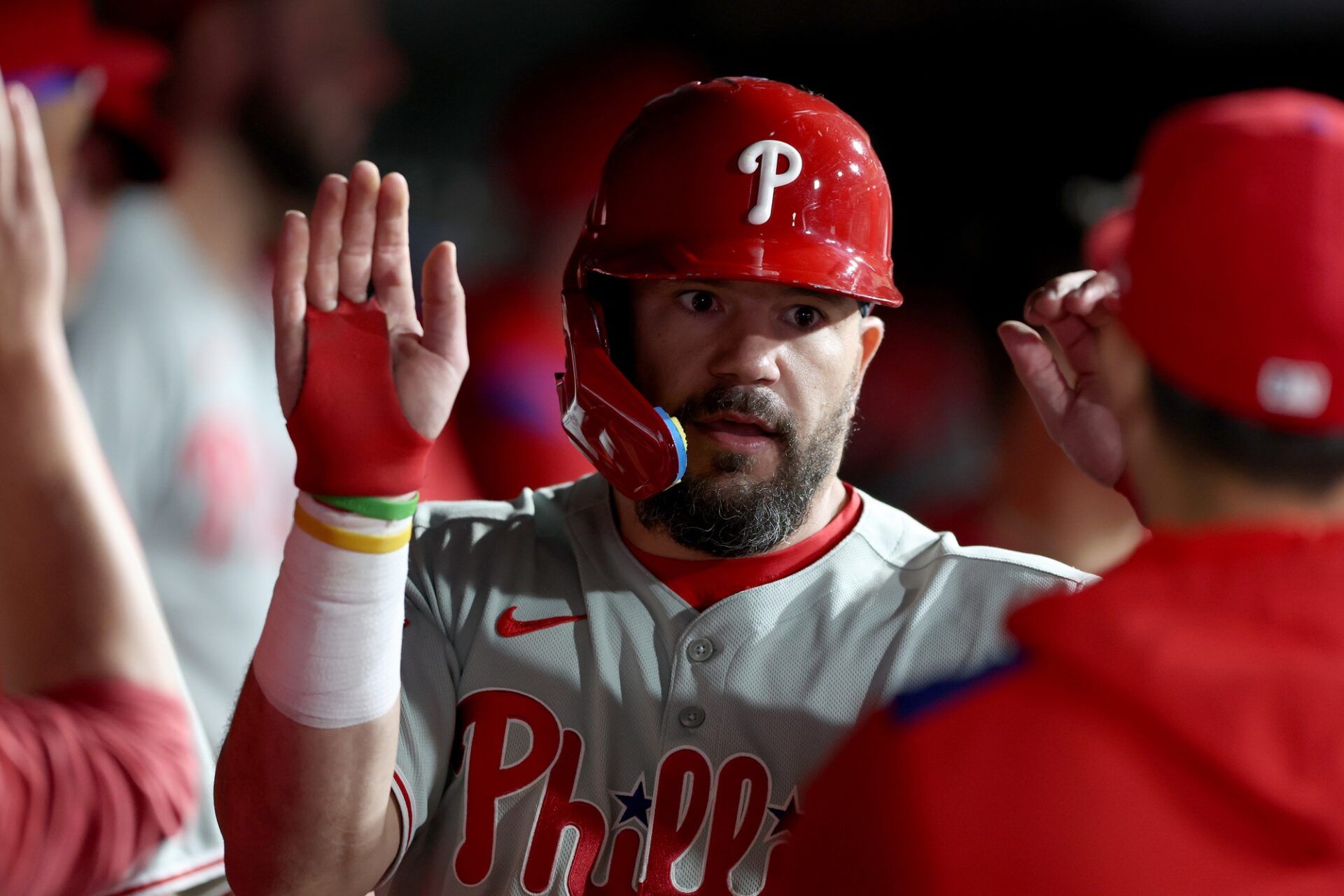 Philadelphia Phillies designated hitter Kyle Schwarber (12) is congratulated by teammates in the dugout after scoring a run against the Athletics during the eleventh inning at Sutter Health Park.
