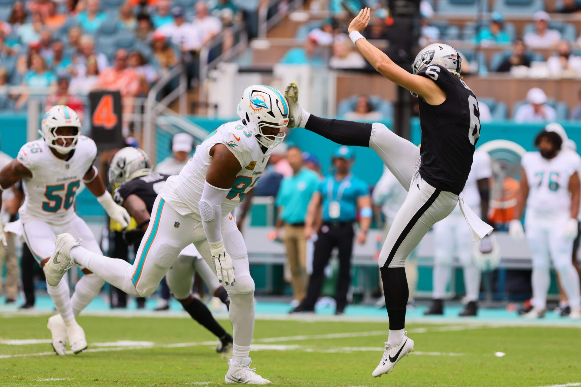 Las Vegas Raiders punter AJ Cole (6) kicks Miami Dolphins defensive tackle Calais Campbell (93) in the helmet during the first quarter at Hard Rock Stadium.