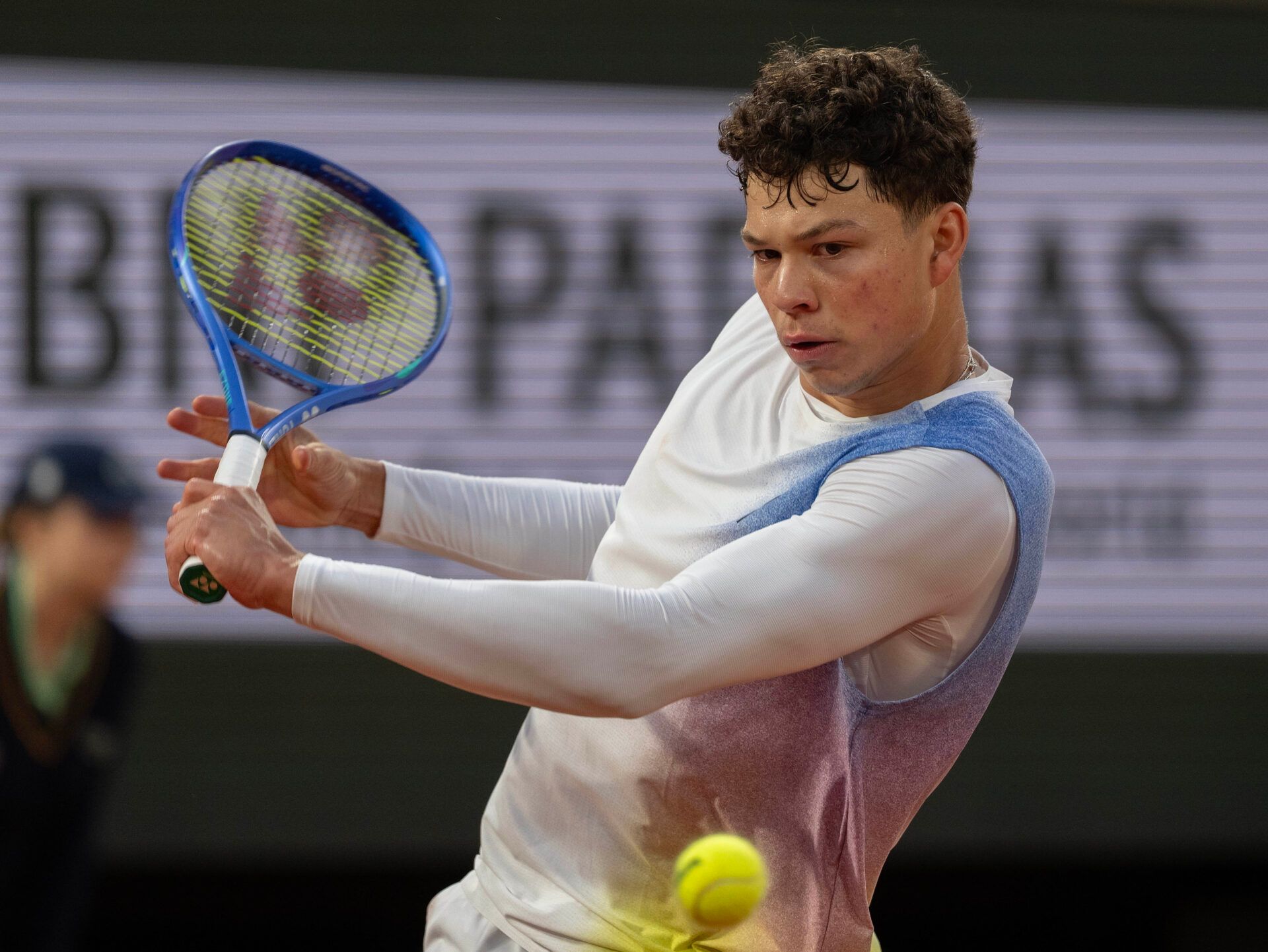 Ben Shelton of the United States returns a shot during his match against Lorenzo Sonego of Italy on day one at Roland Garros Stadium.
