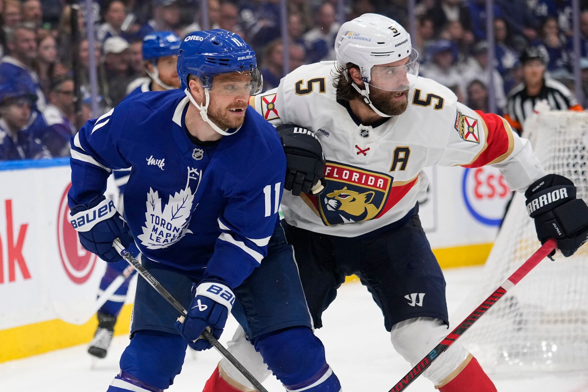 Toronto Maple Leafs forward Max Domi (11) and Florida Panthers defenseman Aaron Ekblad (5) battle for position during the third period of game seven of the second round of the 2025 Stanley Cup Playoffs at Scotiabank Arena.