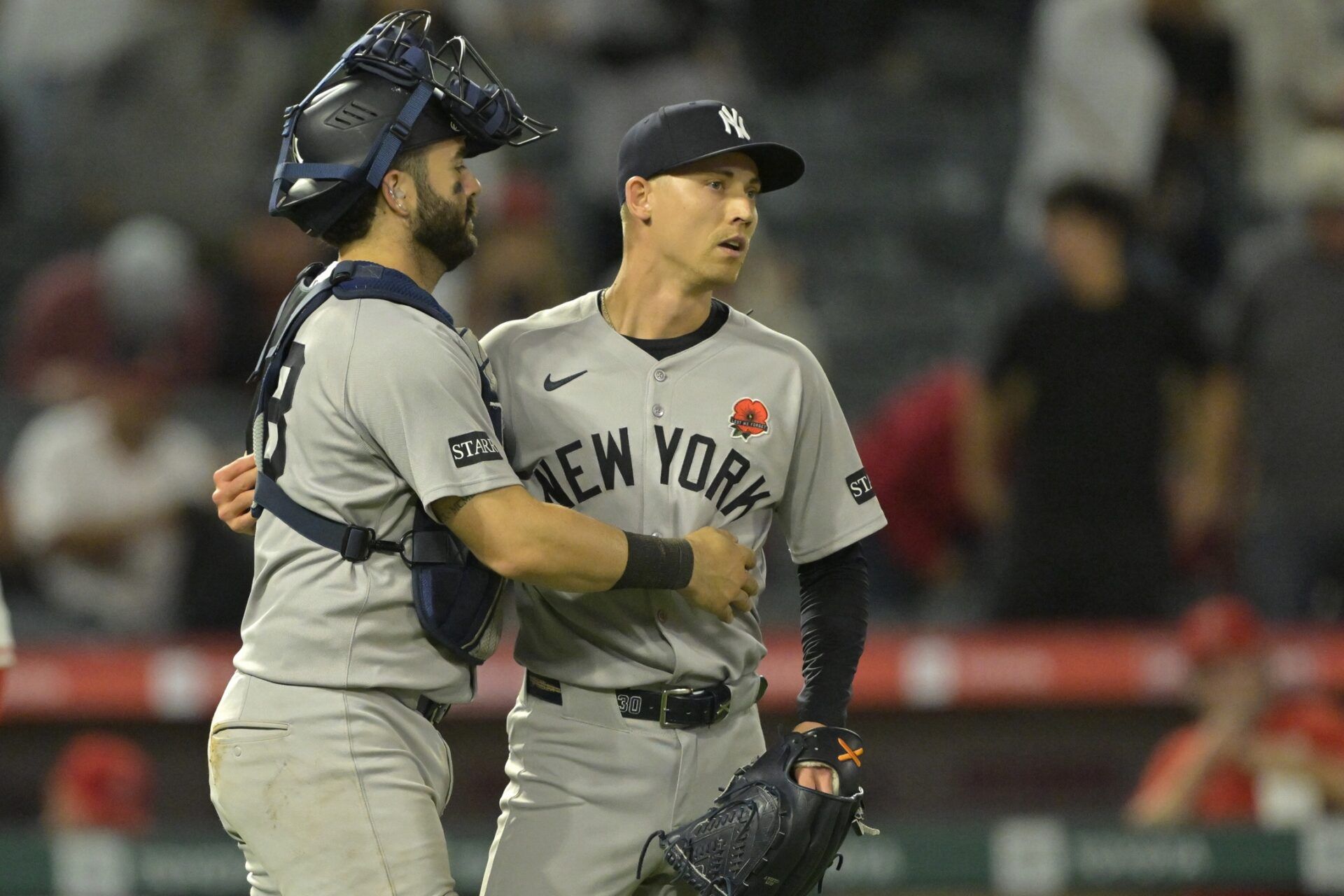 New York Yankees relief pitcher Luke Weaver (30) is congratulated by catcher Austin Wells (28) after the final out of the ninth inning against the Los Angeles Angels at Angel Stadium.