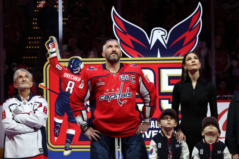 (L-R) Washington Capitals owner Ted Leonsis, Capitals left wing Alex Ovechkin (8), Ovechkin's wife Nastya, and sons Sergei and Ilya watch a video during a ceremony honoring Ovechkin's becoming the NHL all-time goals leader prior to the Capitals' game against the Carolina Hurricanes at Capital One Arena.