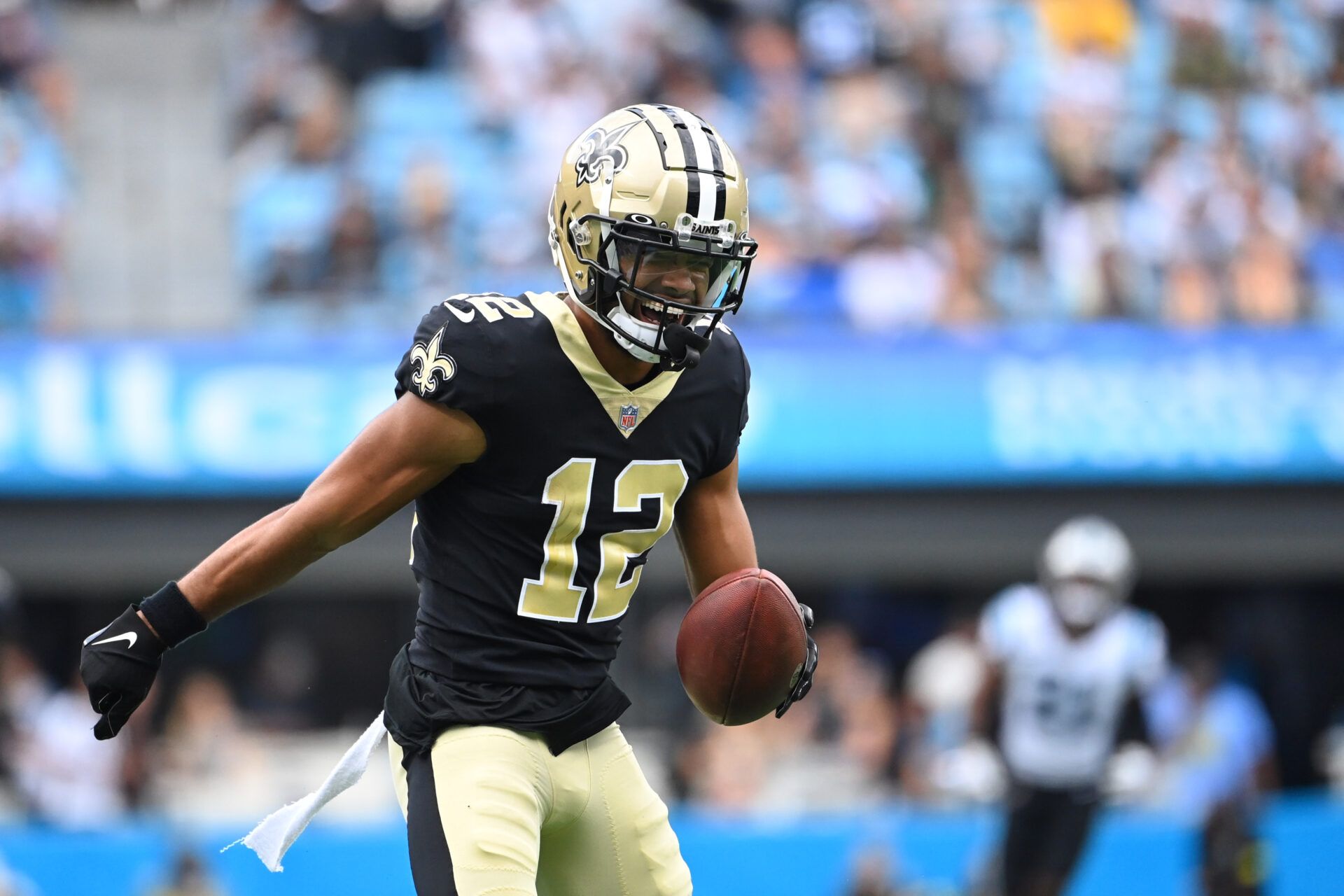 New Orleans Saints wide receiver Chris Olave (12) reacts after catching the ball in the second quarter at Bank of America Stadium.