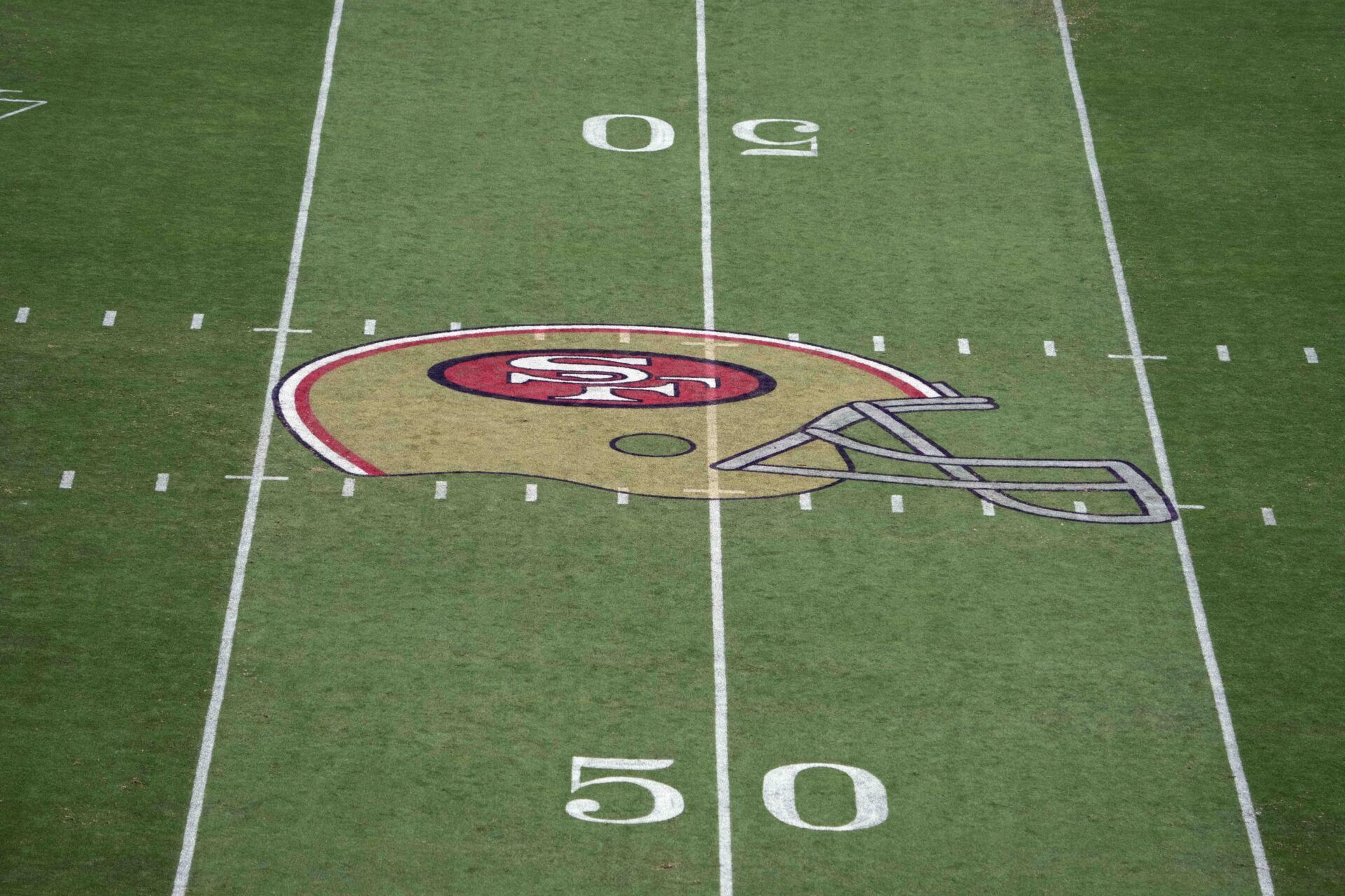 A detailed view of the San Francisco 49ers helmet logo at midfield at Levi's Stadium.