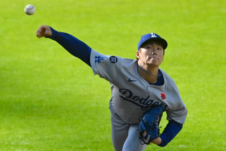 Los Angeles Dodgers starting pitcher Yoshinobu Yamamoto (18) delivers a pitch in the first inning against the Cleveland Guardians at Progressive Field.