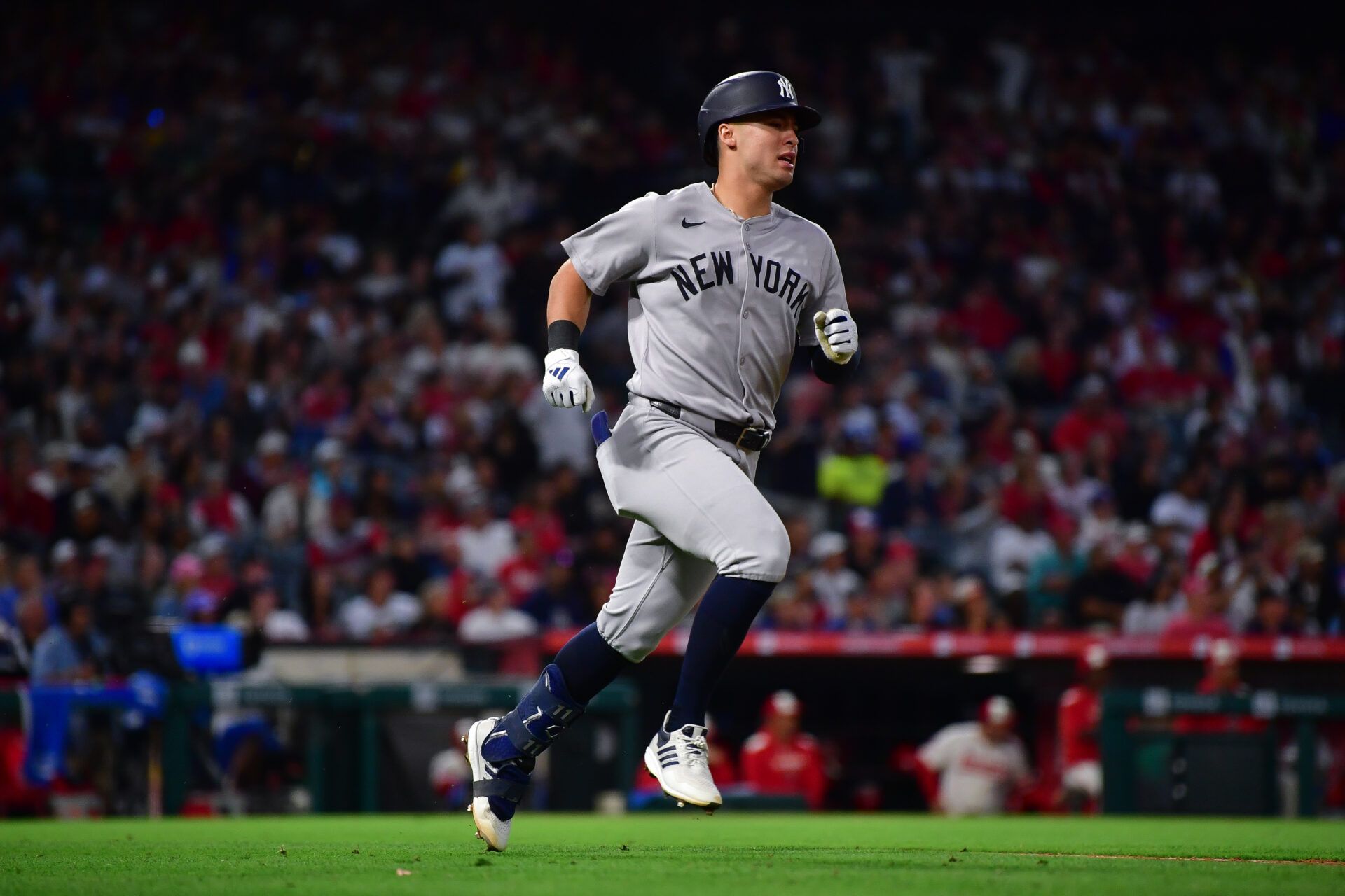 New York Yankees shortstop Anthony Volpe (11) runs after hitting an RBI single against the Los Angeles Angels during the sixth inning at Angel Stadium.