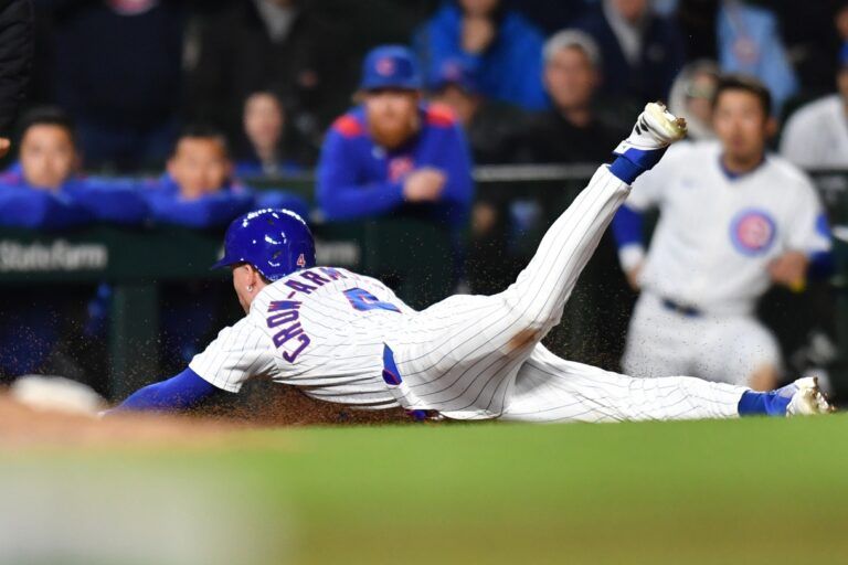 Chicago Cubs center fielder Pete Crow-Armstrong (4) steals third base during the eleventh inning against the Colorado Rockies at Wrigley Field.