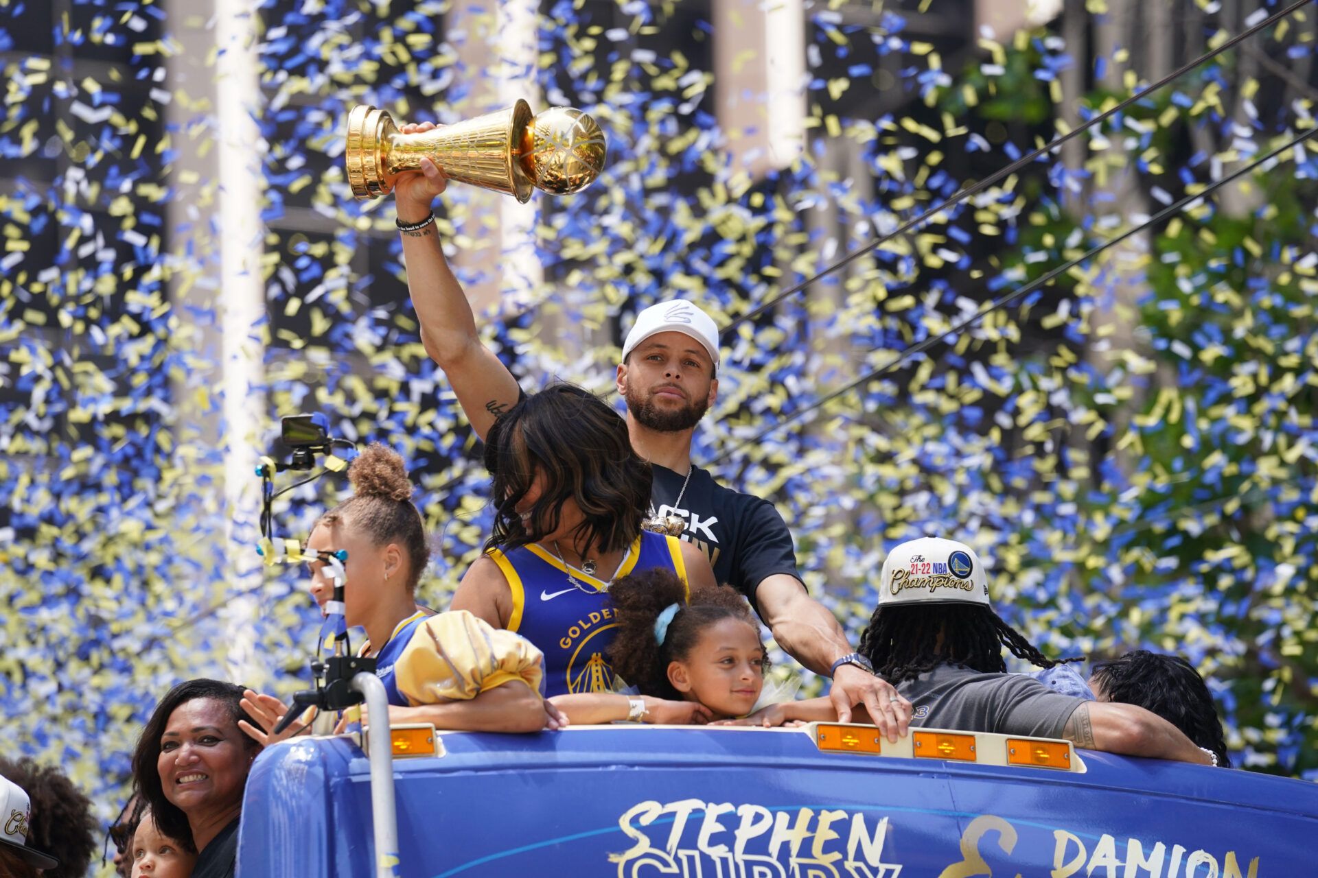 Golden State Warriors guard Stephen Curry holds the NBA Finals Most Valuable Player Award trophy during the Warriors championship parade in downtown San Francisco.