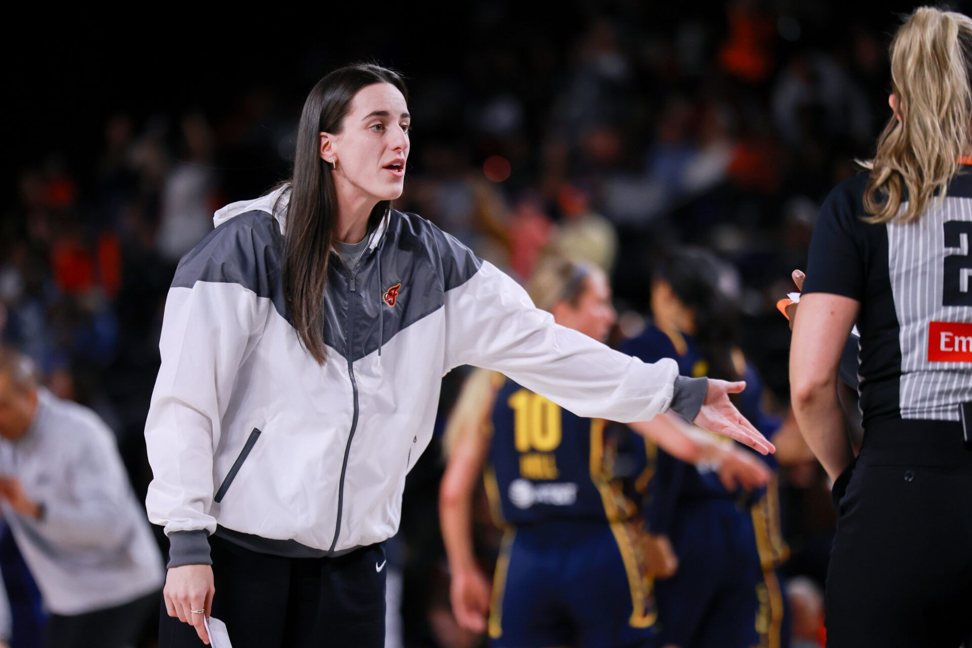 Indiana Fever guard Caitlin Clark talks with the referee after the second quarter agains the Washington Mystics at Entertainment & Sports Arena.