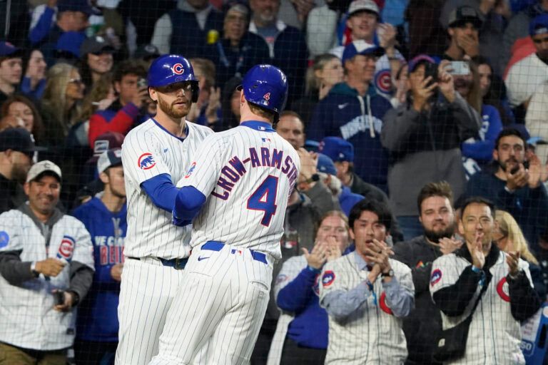 Chicago Cubs outfielder Pete Crow-Armstrong (4) is greeted after hitting a home run against the Colorado Rockies during the fourth inning at Wrigley Field.