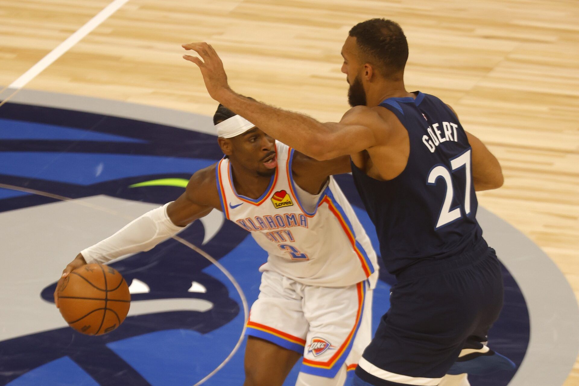 Oklahoma City Thunder guard Shai Gilgeous-Alexander (2) dribbles the ball against Minnesota Timberwolves center Rudy Gobert (27) during the first half in game three of the western conference finals for the 2025 NBA Playoffs at Target Center.