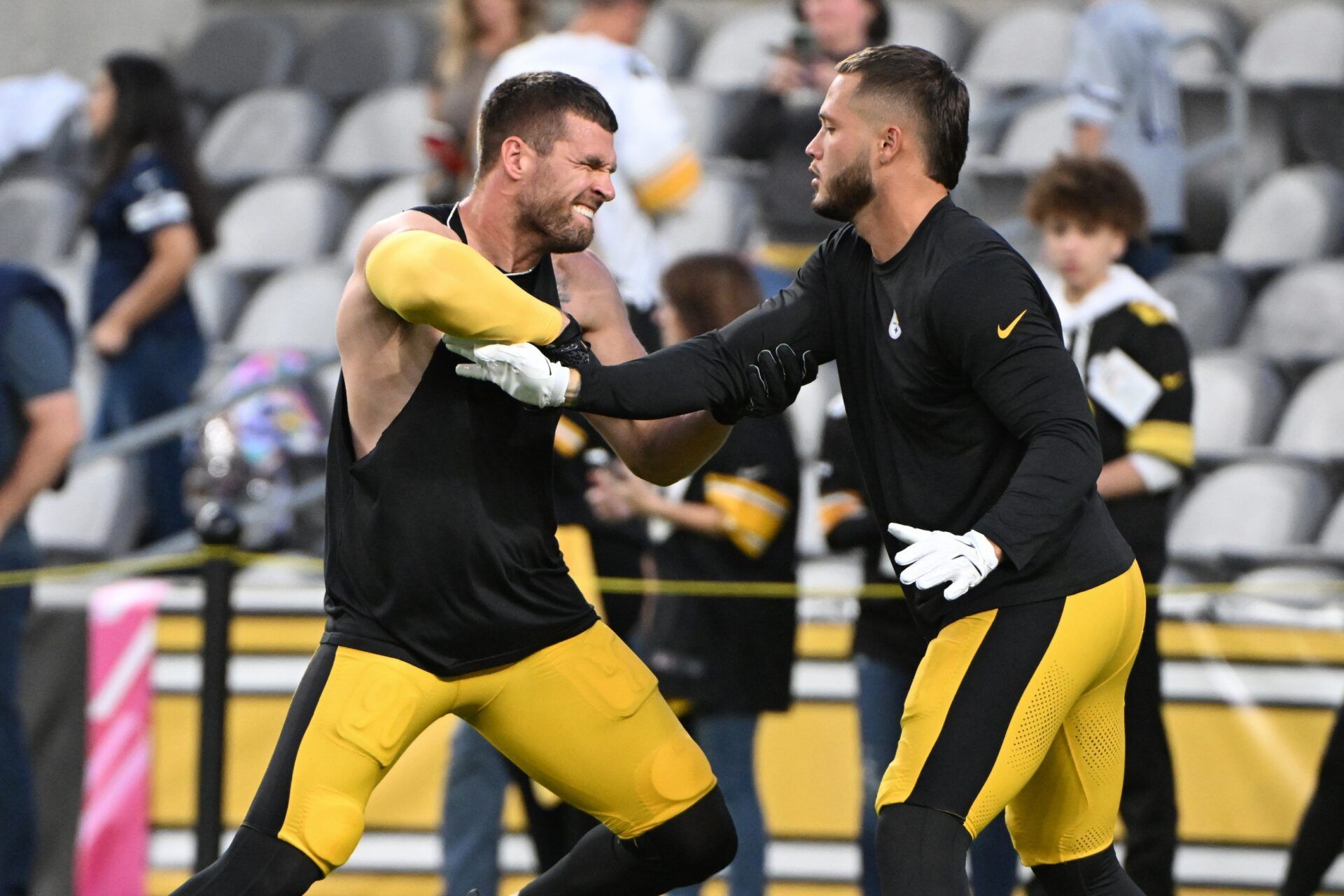 Pittsburgh Steelers linebackers T.J. Watt (90) and Nick Herbig (51) work out before a game against the Dallas Cowboys at Acrisure Stadium.