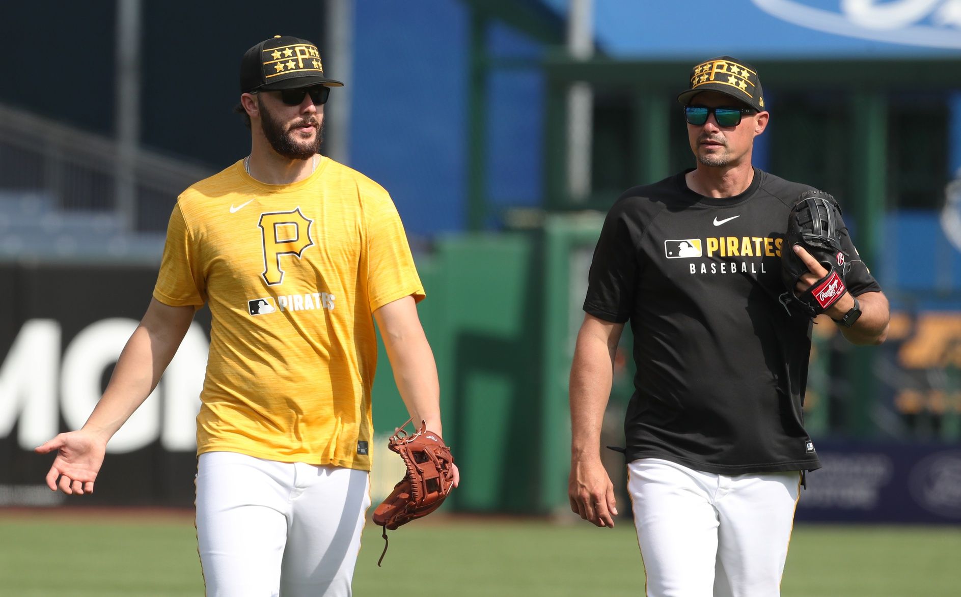 Pittsburgh Pirates pitcher Paul Skenes (left) and bench coach Don Kelly (right) talk in the outfield before the game against the Chicago Cubs at PNC Park.