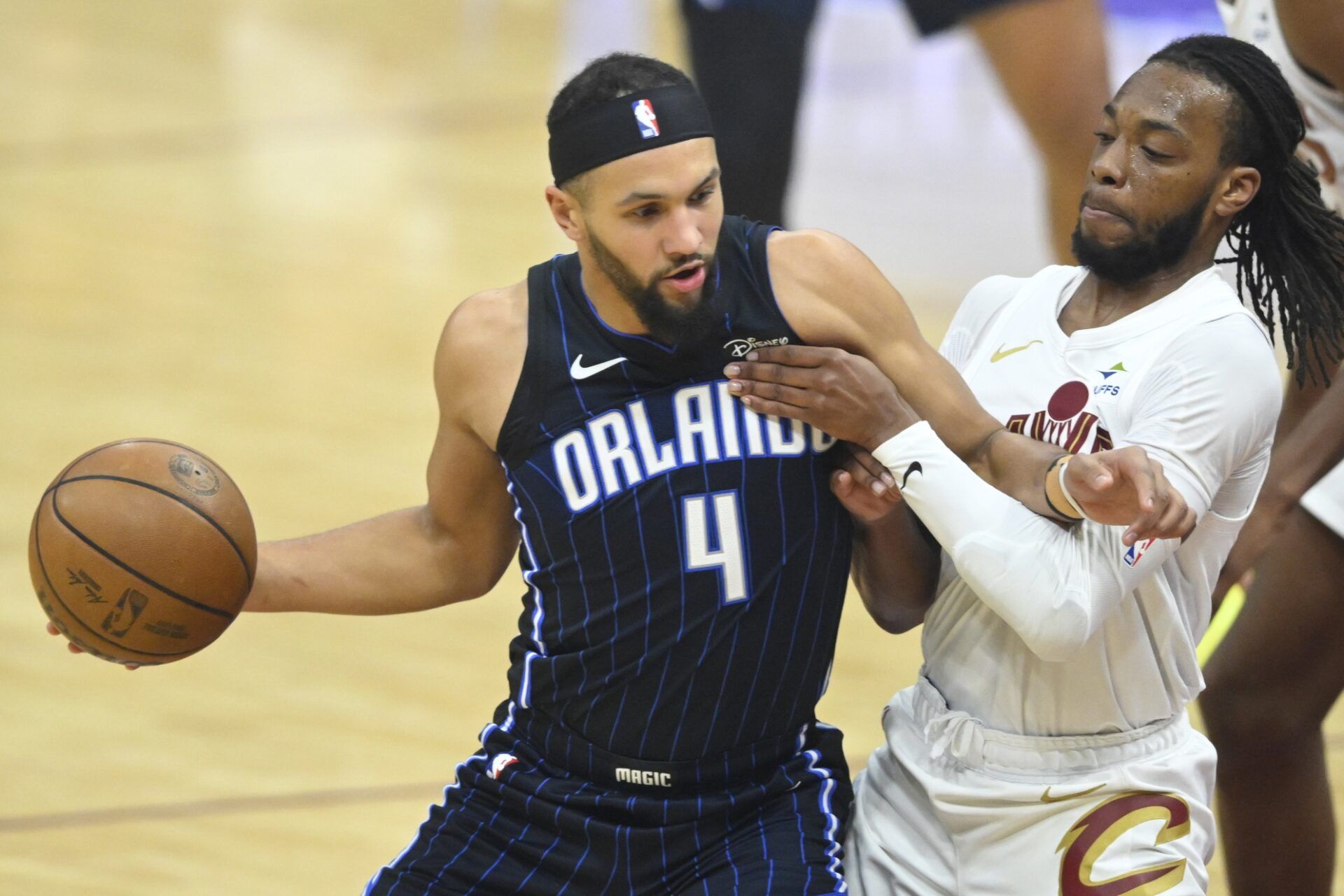 Orlando Magic guard Jalen Suggs (4) dribbles beside Cleveland Cavaliers guard Darius Garland (10) in the first quarter at Rocket Mortgage FieldHouse.