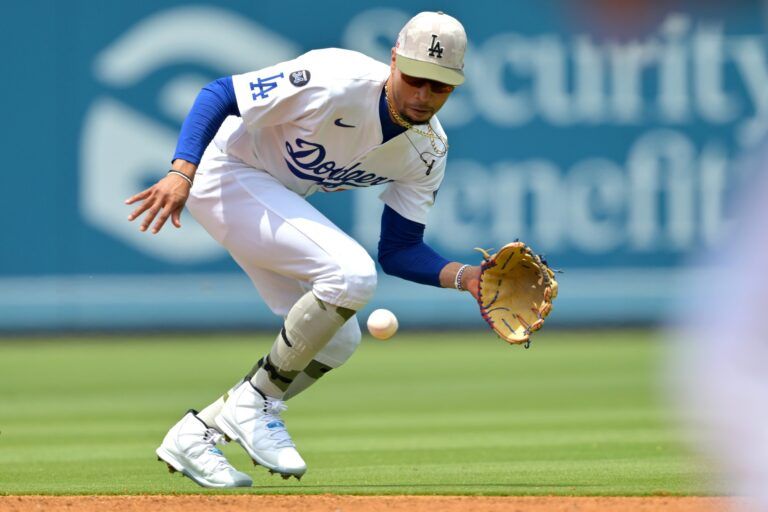 Los Angeles Dodgers shortstop Mookie Betts (50) makes a play and throws Los Angeles Angels third baseman Luis Rengifo (2) out at first in the second inning at Dodger Stadium.