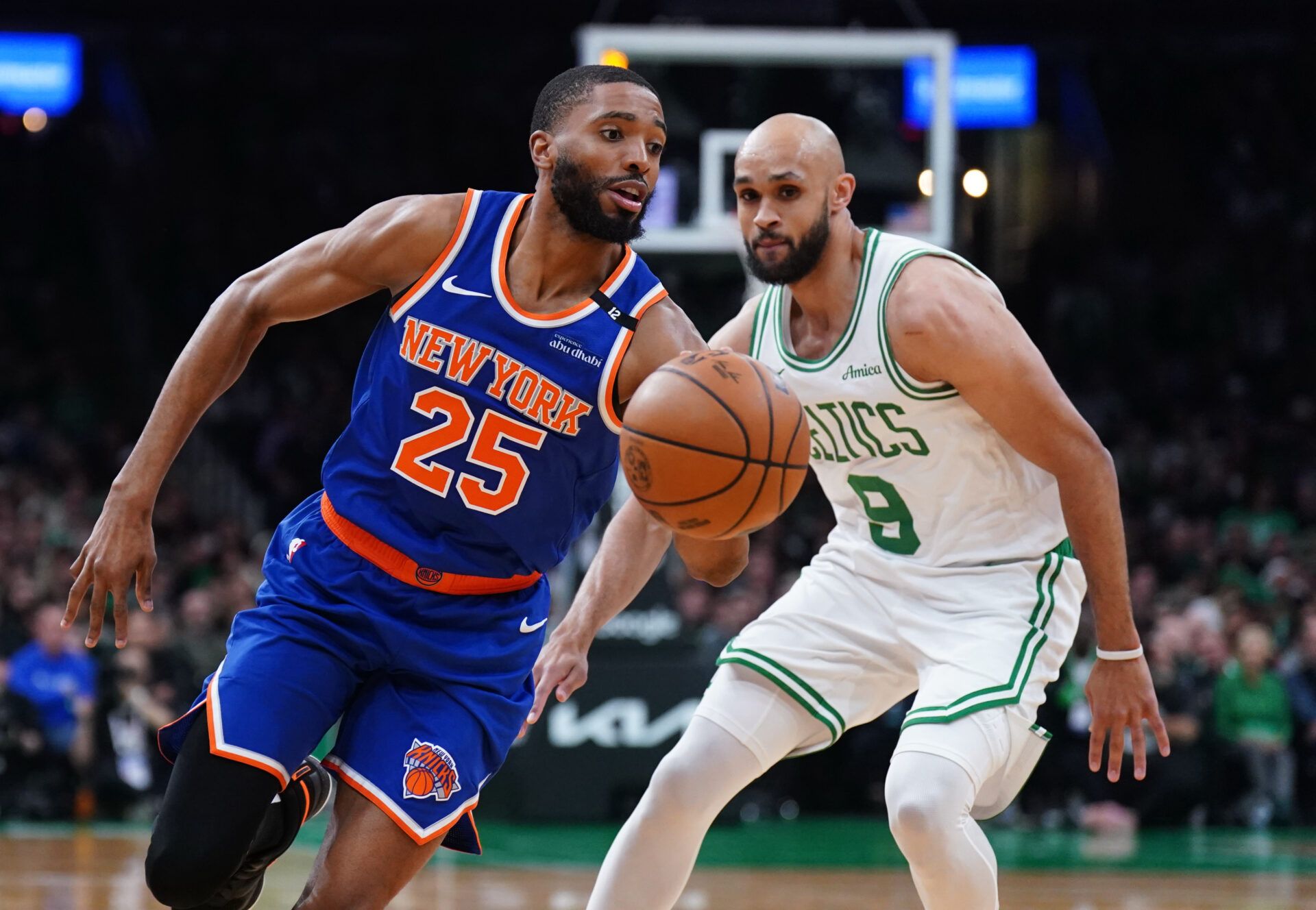 New York Knicks forward Mikal Bridges (25) drives the ball against Boston Celtics guard Derrick White (9) in the first quarter during game one of the second round for the 2025 NBA Playoffs at TD Garden.