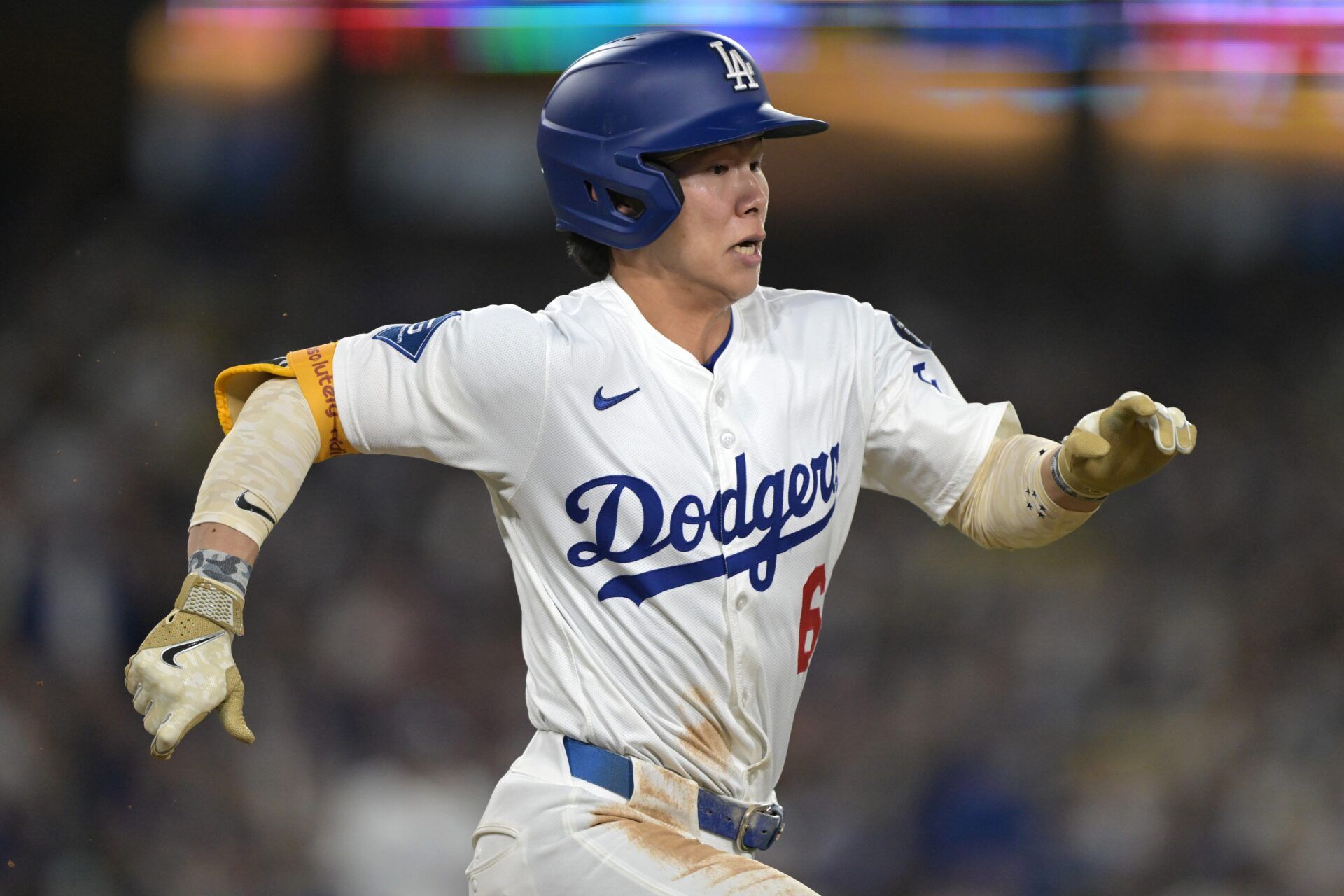 Los Angeles Dodgers second baseman Hyeseong Kim (6) beats out an infield hit in the fourth inning against the Los Angeles Angels at Dodger Stadium.