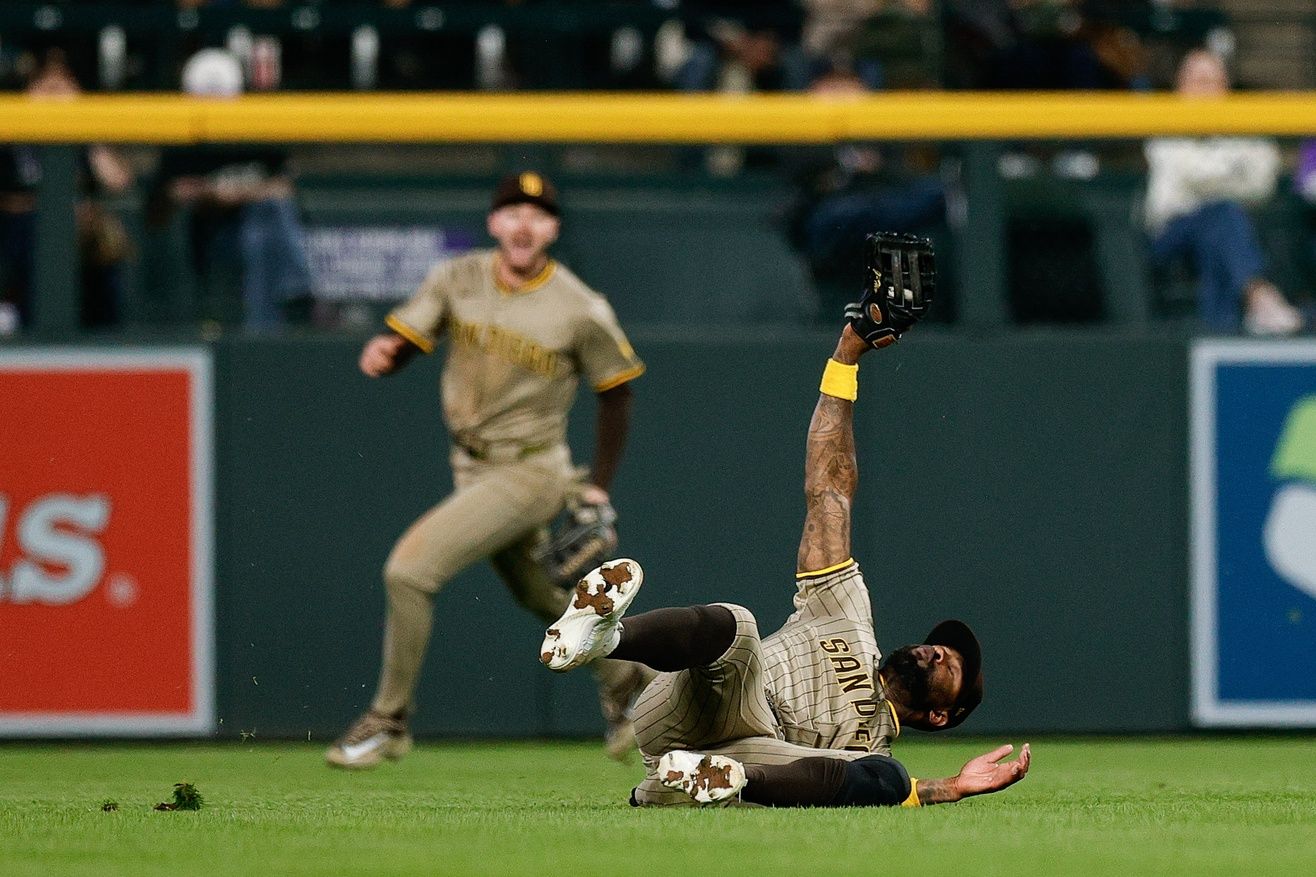 San Diego Padres left fielder Jason Heyward (22) makes a diving catch in the fifth inning against the Colorado Rockies at Coors Field.