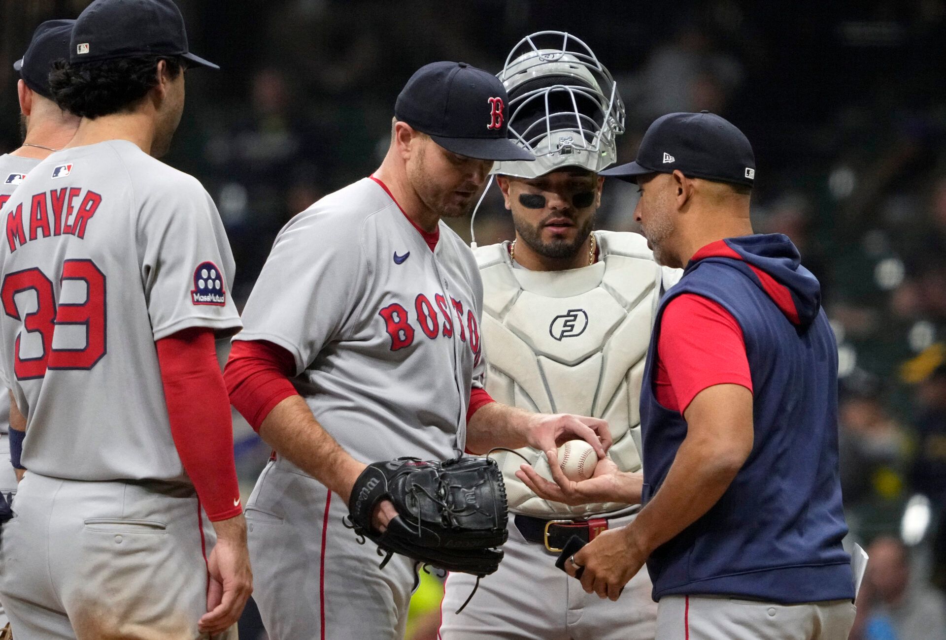 Boston Red Sox manager Alex Cora (13) takes the ball from Boston Red Sox pitcher Justin Wilson (32) in the seventh inning at American Family Field.