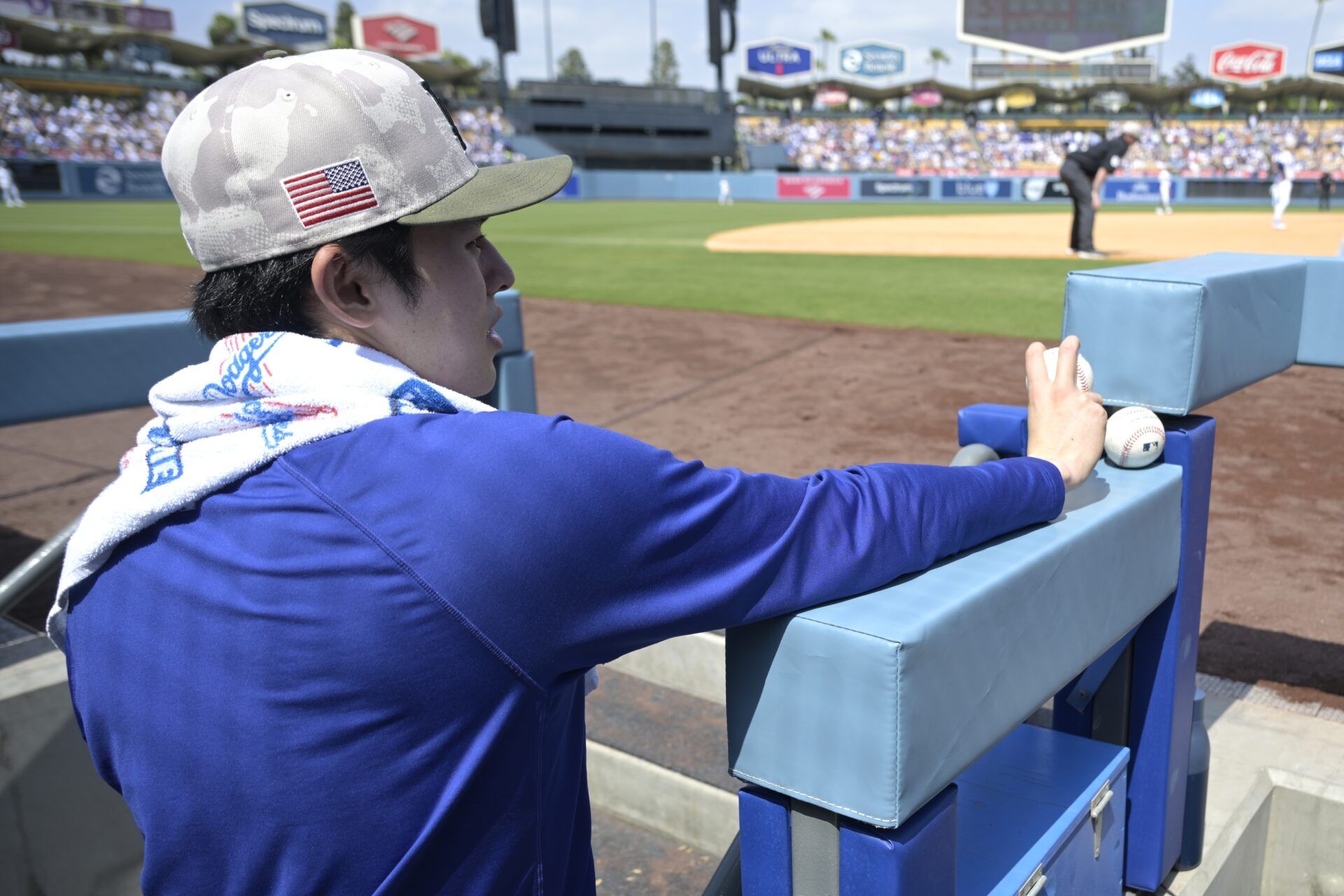 Los Angeles Dodgers starting pitcher Roki Sasaki (11) looks on from the dugout during the game against the Los Angeles Angels at Dodger Stadium.