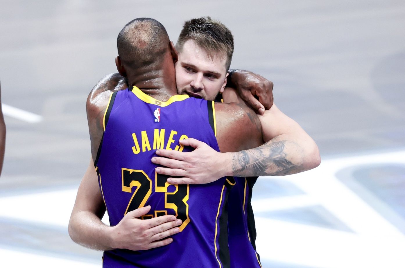 Los Angeles Lakers guard Luka Doncic (77) celebrates with Los Angeles Lakers forward LeBron James (23) during the fourth quarter against the Dallas Mavericks at American Airlines Center.