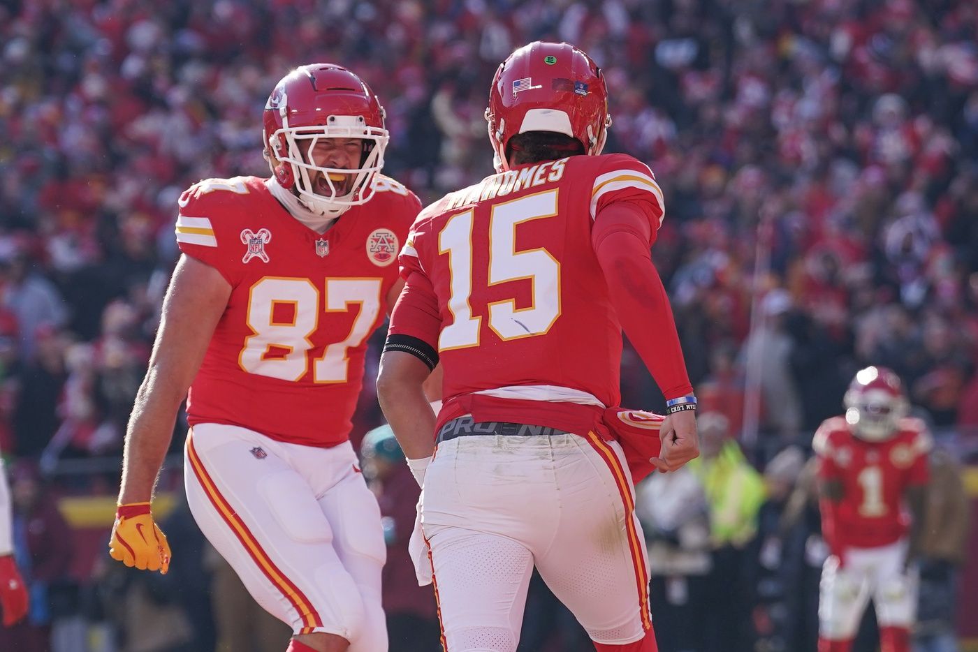 Kansas City Chiefs tight end Travis Kelce (87) celebrates with quarterback Patrick Mahomes (15) after Mahomes’ touchdown against the Houston Texans during the first half at GEHA Field at Arrowhead Stadium.