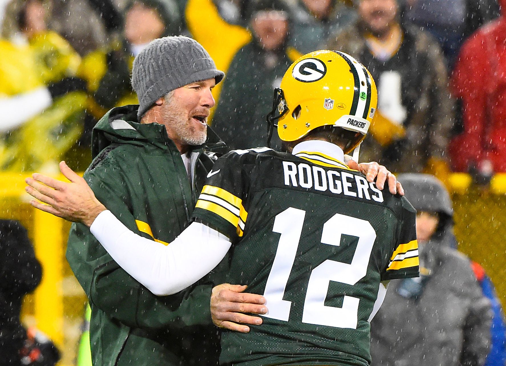 Green Bay Packers former quarterback Brett Favre hugs Green Bay Packers quarterback Aaron Rodgers (12) at half time for a NFL game against the Chicago Bears on Thanksgiving at Lambeau Field.