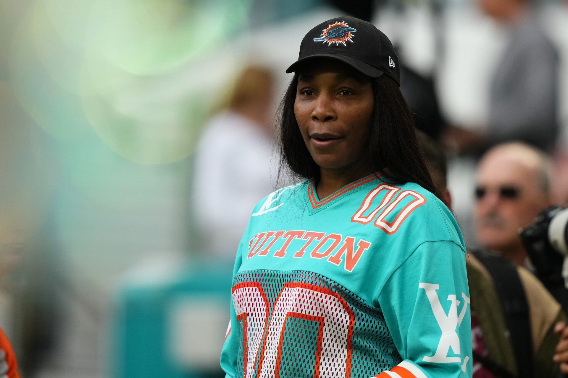 American professional tennis player. Venus Williams stands on the field prior to the game between the Miami Dolphins and the Dallas Cowboys at Hard Rock Stadium.