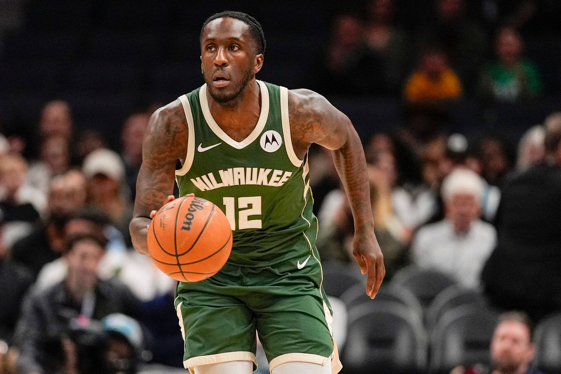 Milwaukee Bucks forward Taurean Prince (12) brings the ball up court against the Charlotte Hornets during the first half at Spectrum Center.