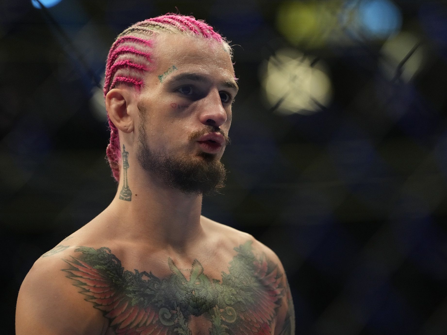 Pedro Munhoz (red gloves) reacts after his bout against  Sean O'Malley (blue gloves) resulted in a no decision due to an accidental foul during UFC 276 at T-Mobile Arena.