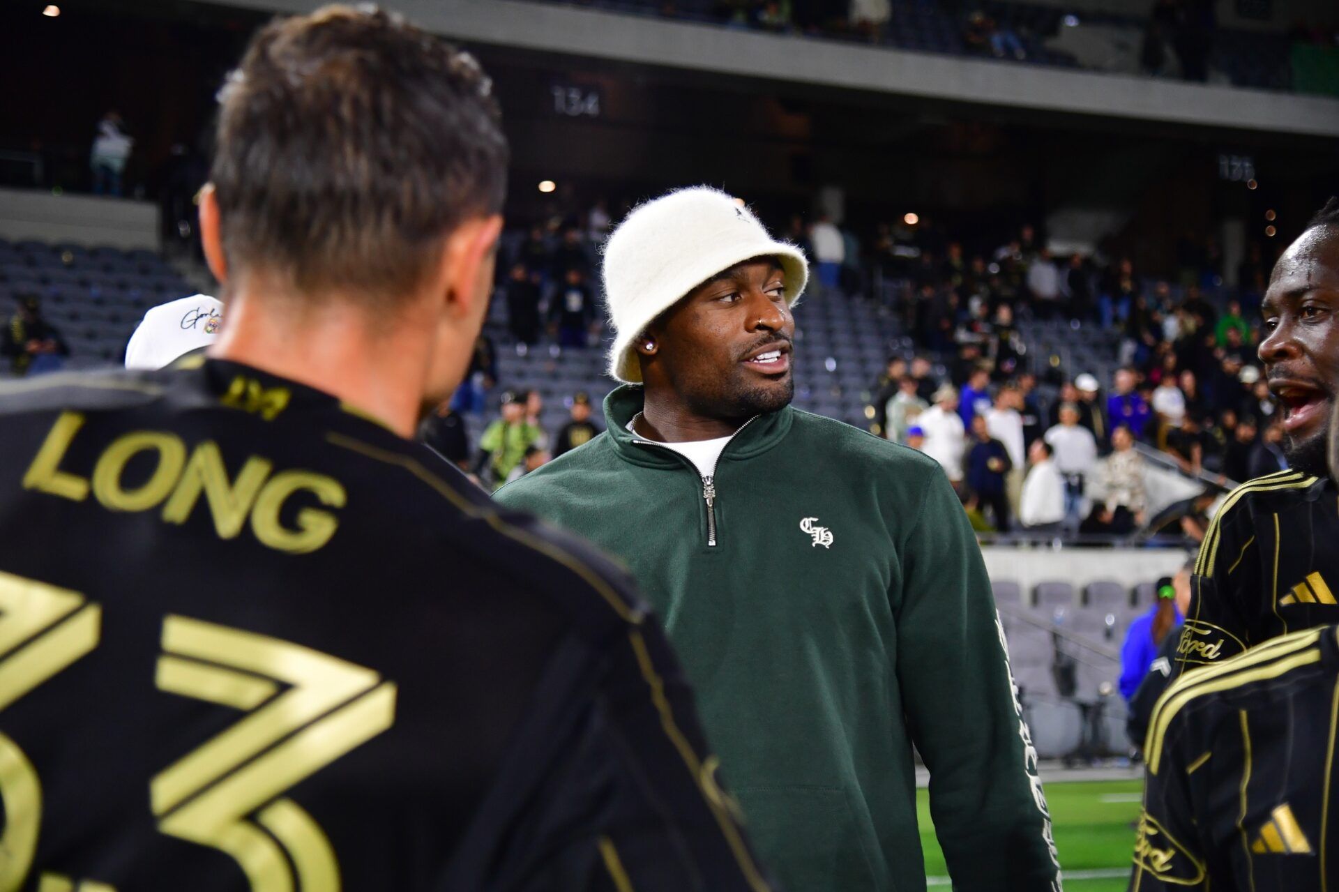Seattle Seahawks player D.K. Metcalf congratulates LAFC players after a victory against Minnesota United at BMO Stadium.