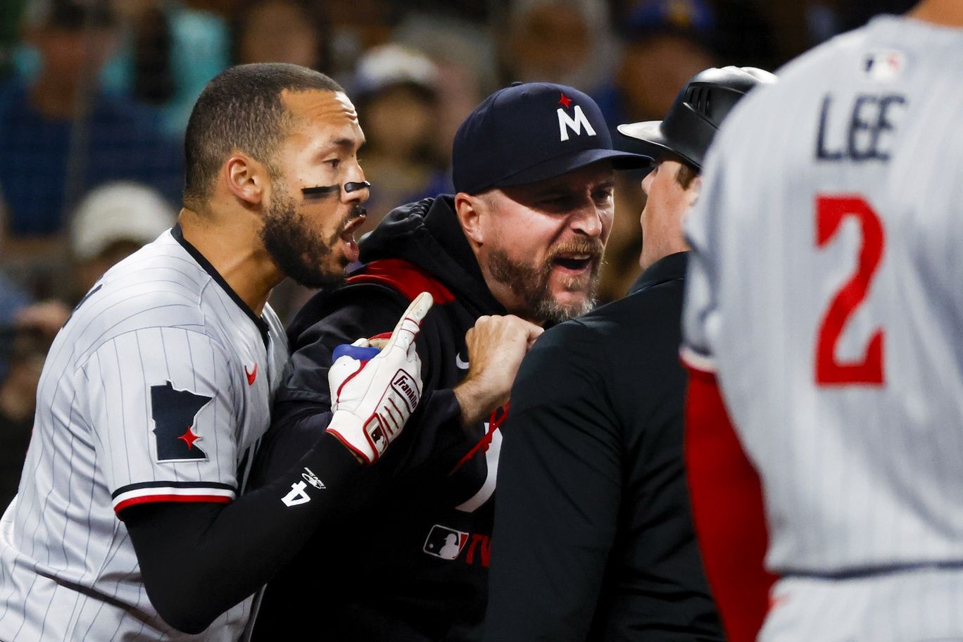 Minnesota Twins shortstop Carlos Correa (4, left) and manager Rocco Baldelli (5, middle) argue with umpire Austin Jones (right) during the seventh inning against the Seattle Mariners at T-Mobile Park. Correa and Baldelli were both ejected from the game.