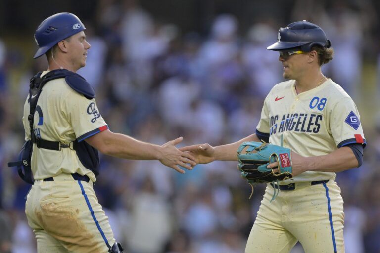 Los Angeles Dodgers first baseman Kiki Hernandez (8) shakes hands with Los Angeles Dodgers catcher Will Smith (16) after pitching a scoreless the ninth inning against the New York Yankees at Dodger Stadium.