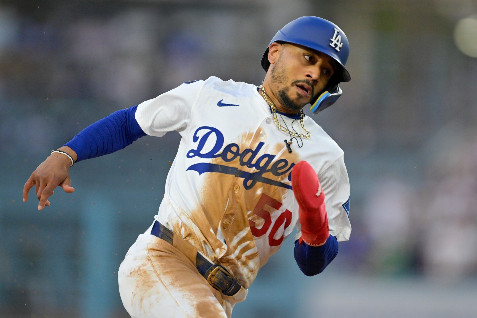 Los Angeles Dodgers shortstop Mookie Betts (50) rounds the bases against the Athletics during the first inning of the game at Dodger Stadium.