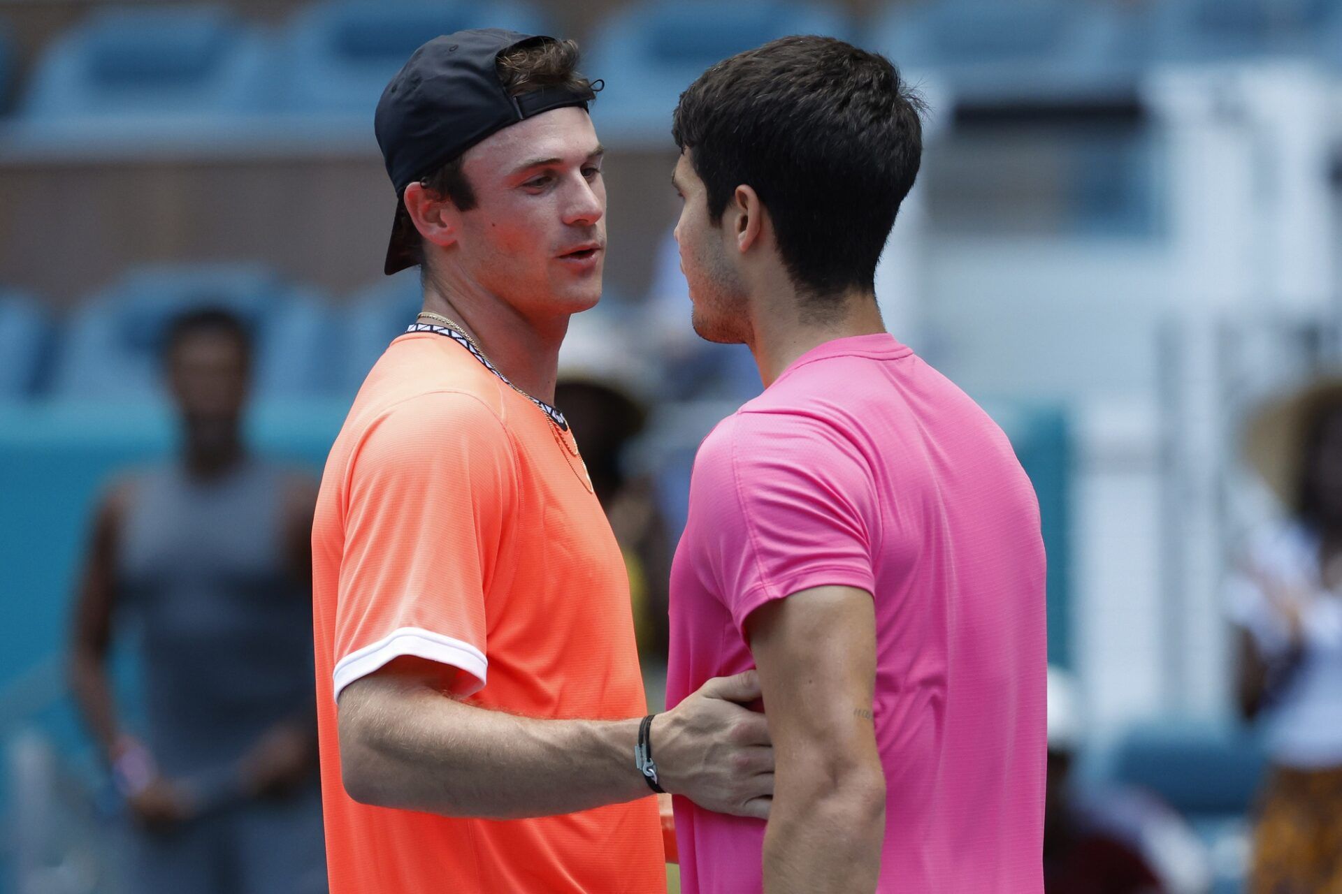 Carlos Alcaraz (ESP) (R) hugs Tommy Paul (USA) (L) after their match on day nine of the Miami Open at Hard Rock Stadium.