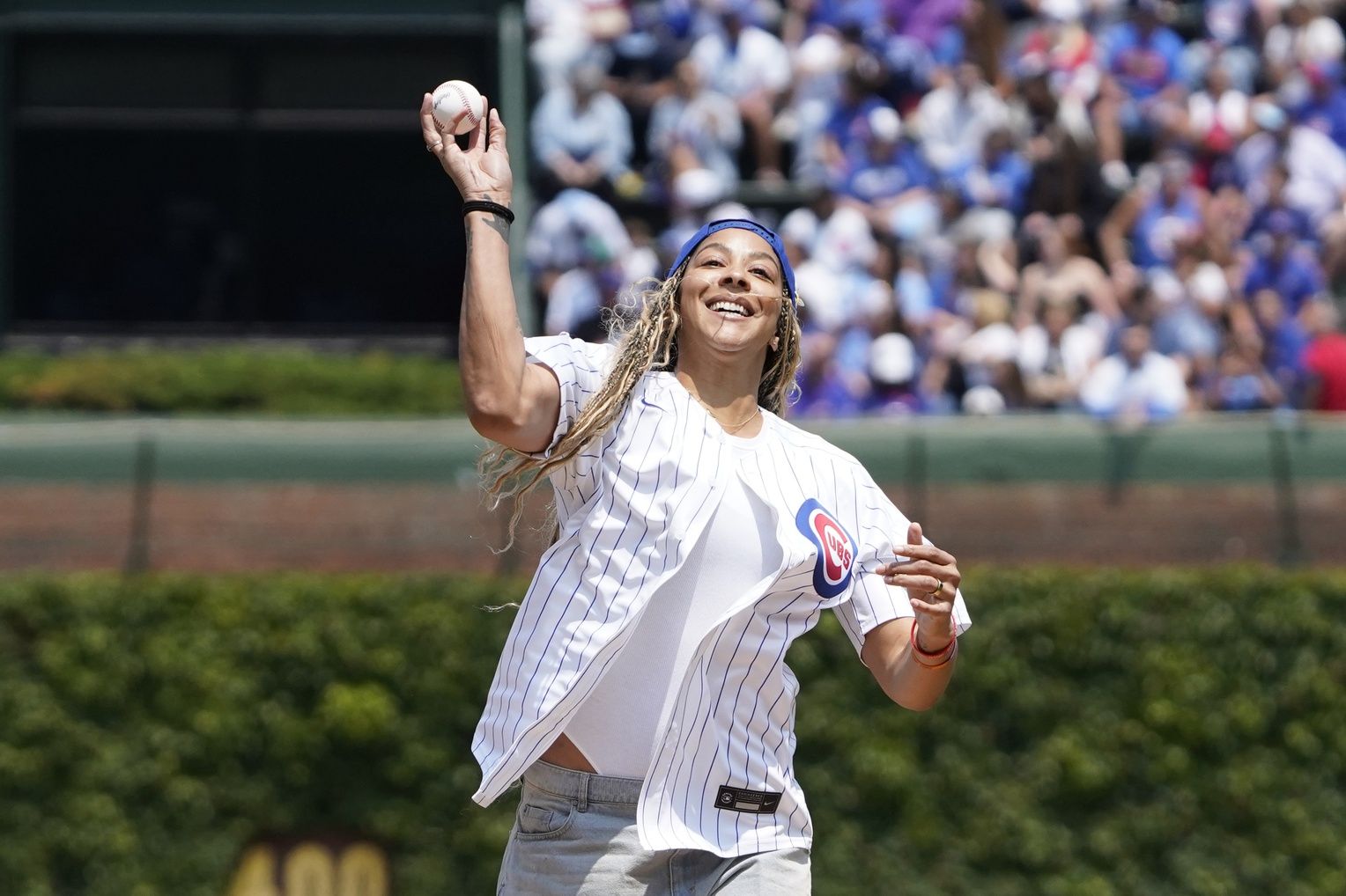 Former WNBA star Candace Parker Throws to a ceremonial first pitch before a game between the Chicago Cubs and the Cincinnati Reds at Wrigley Field.
