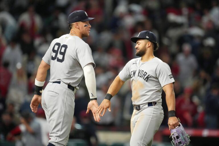 New York Yankees designated hitter Aaron Judge (99) and left fielder Jasson Dominguez (24) react after the game against the Los Angeles Angels at Angel Stadium.