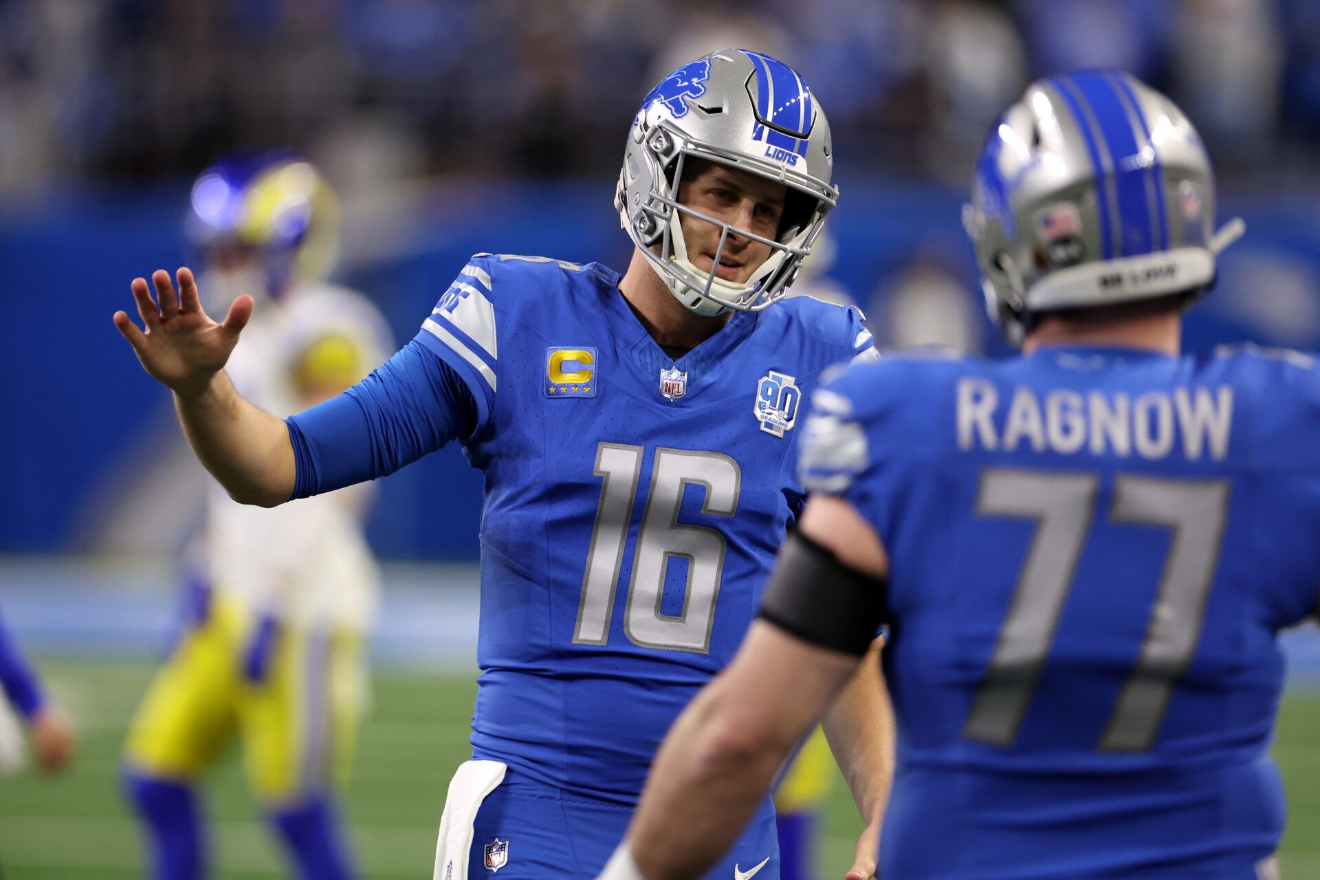 DETROIT, MICHIGAN - JANUARY 14: Jared Goff #16 of the Detroit Lions shakes hands with Frank Ragnow #77 prior to a game against the Los Angeles Rams in the NFC Wild Card Playoffs at Ford Field on January 14, 2024 in Detroit, Michigan. (Photo by Gregory Shamus/Getty Images)