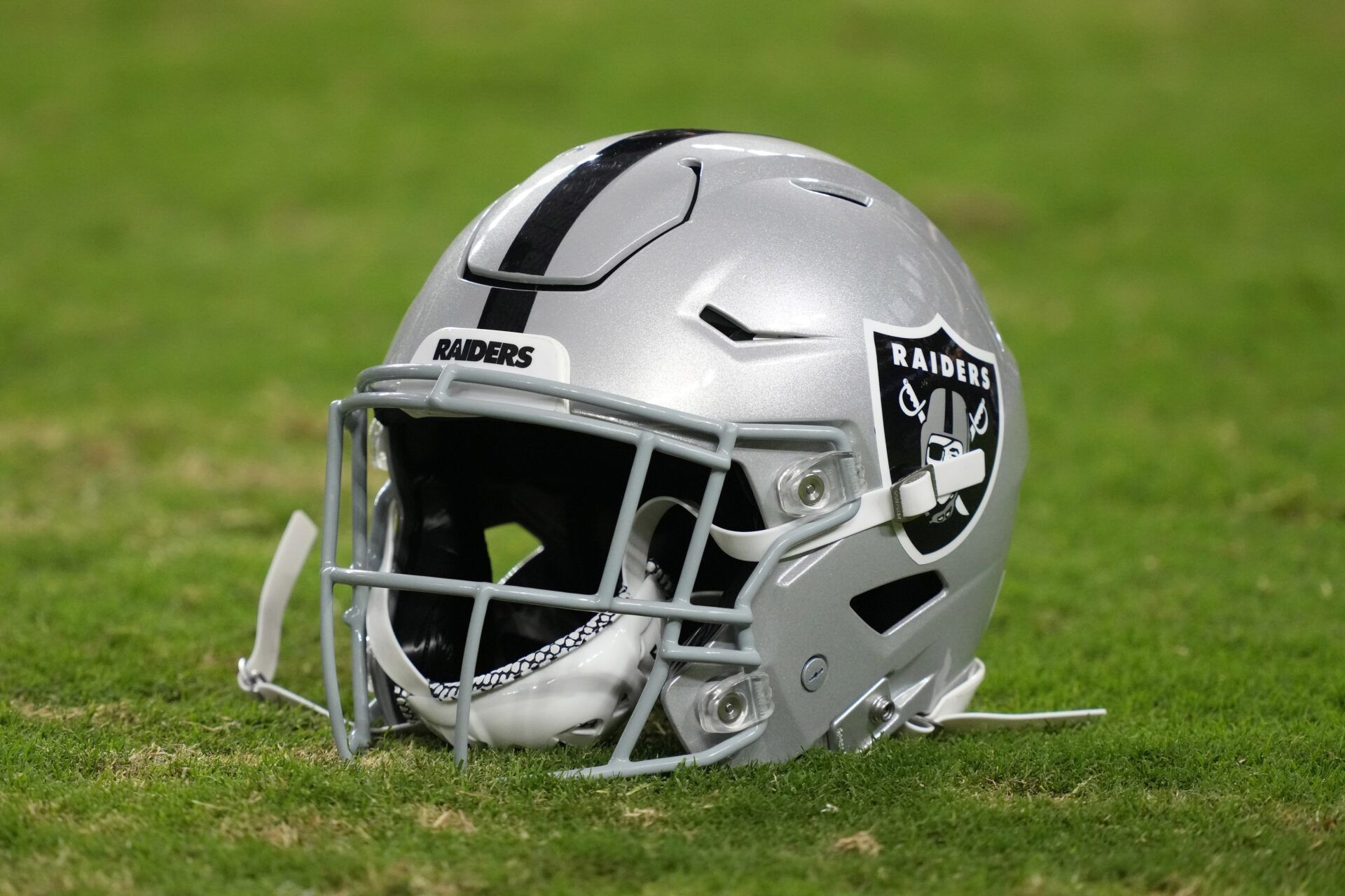A Las Vegas Raiders Riddell speedflex helmet on the field at Allegiant Stadium.