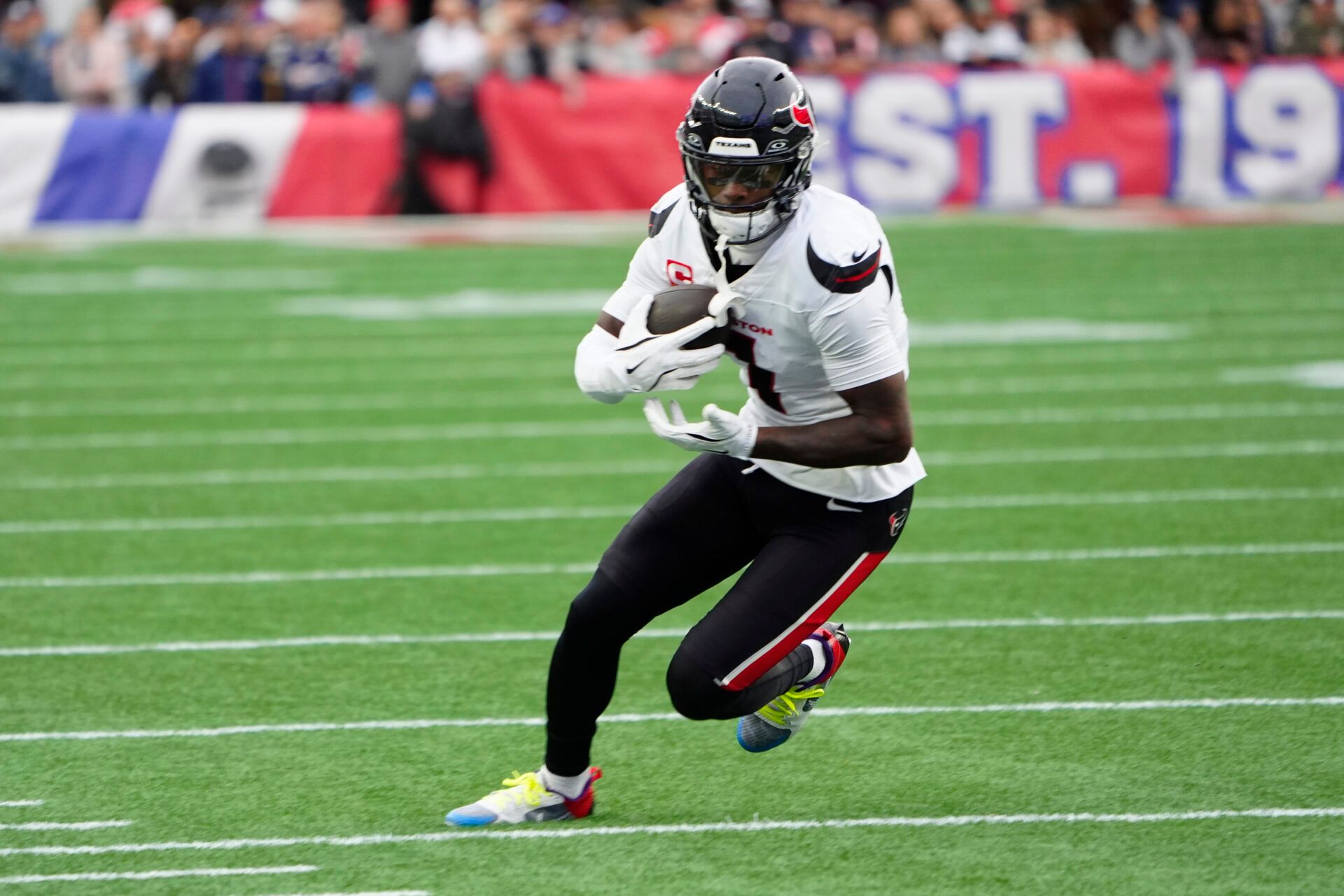 Houston Texans wide receiver Stefon Diggs (1) runs with the ball after making a catch against the New England Patriots during the first half at Gillette Stadium.