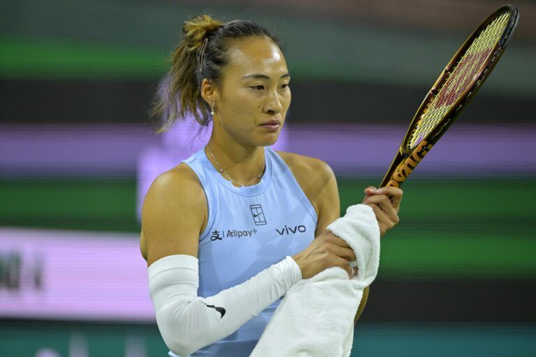 Qinwen Zheng (CHI) wipes her racket in between points during her third round match where she defeated Marta Kostyuk (not pictured) at the BNP Paribas Open the at Indian Well Tennis Garden.