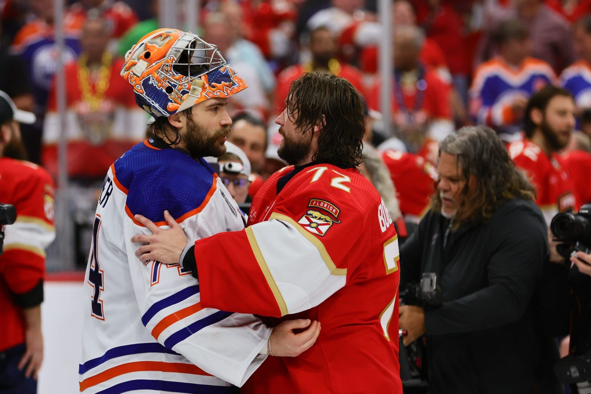 Edmonton Oilers goaltender Stuart Skinner (74) and Florida Panthers goaltender Sergei Bobrovsky (72) talk after game seven of the 2024 Stanley Cup Final at Amerant Bank Arena.