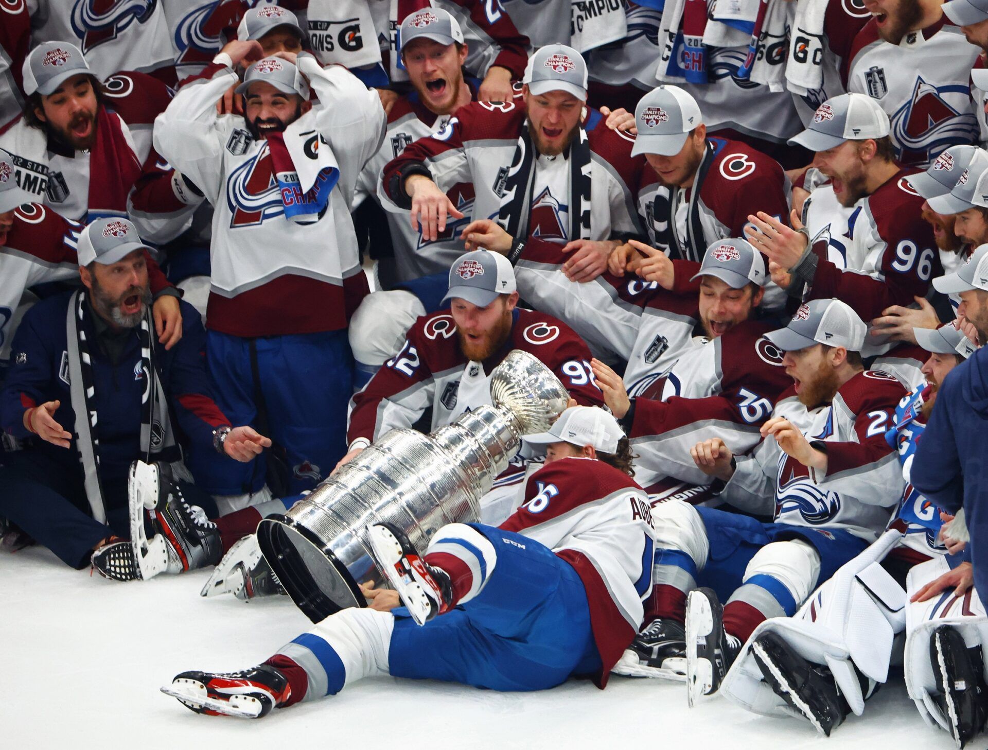 The Colorado Avalanche players react as right wing Nicolas Aube-Kubel (16) falls and drops the Stanley Cup trophy on the ice after defeating the Tampa Bay Lightning to win the Stanley Cup in game six of the 2022 Stanley Cup Final at Amalie Arena.