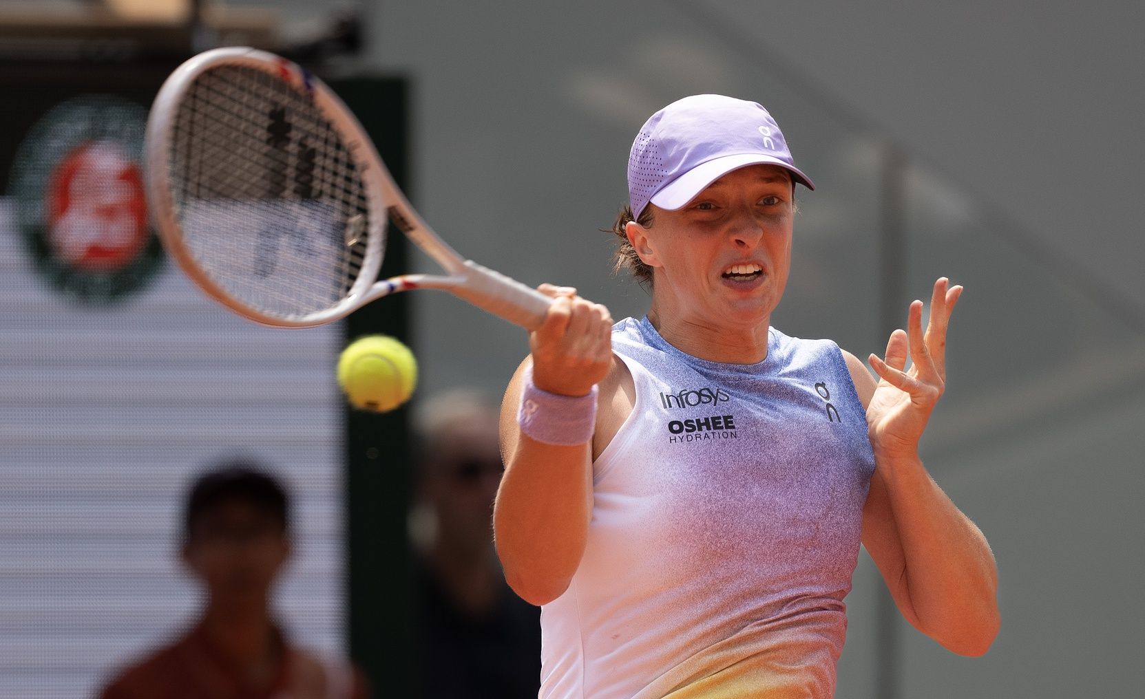 Iga Swiatek of Poland returns a shot during her match against Elina Svitolina of Ukraine on day 10 at Roland Garros Stadium.