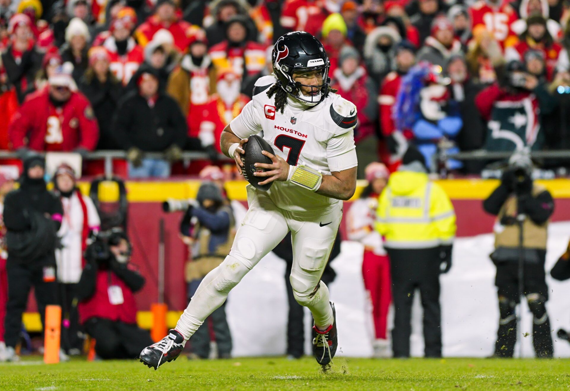 Houston Texans quarterback C.J. Stroud (7) rolls out to pass during the second half against the Kansas City Chiefs in a 2025 AFC divisional round game at GEHA Field at Arrowhead Stadium.