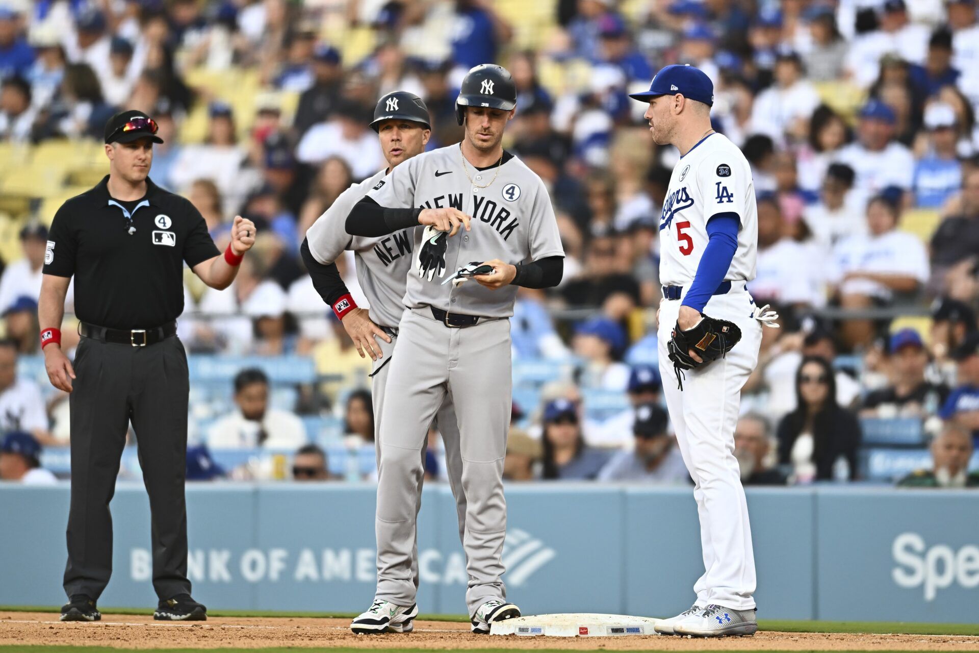 New York Yankees pinch hitter Cody Bellinger (35) walks against Los Angeles Dodgers first baseman Freddie Freeman (5) during the ninth inning at Dodger Stadium.