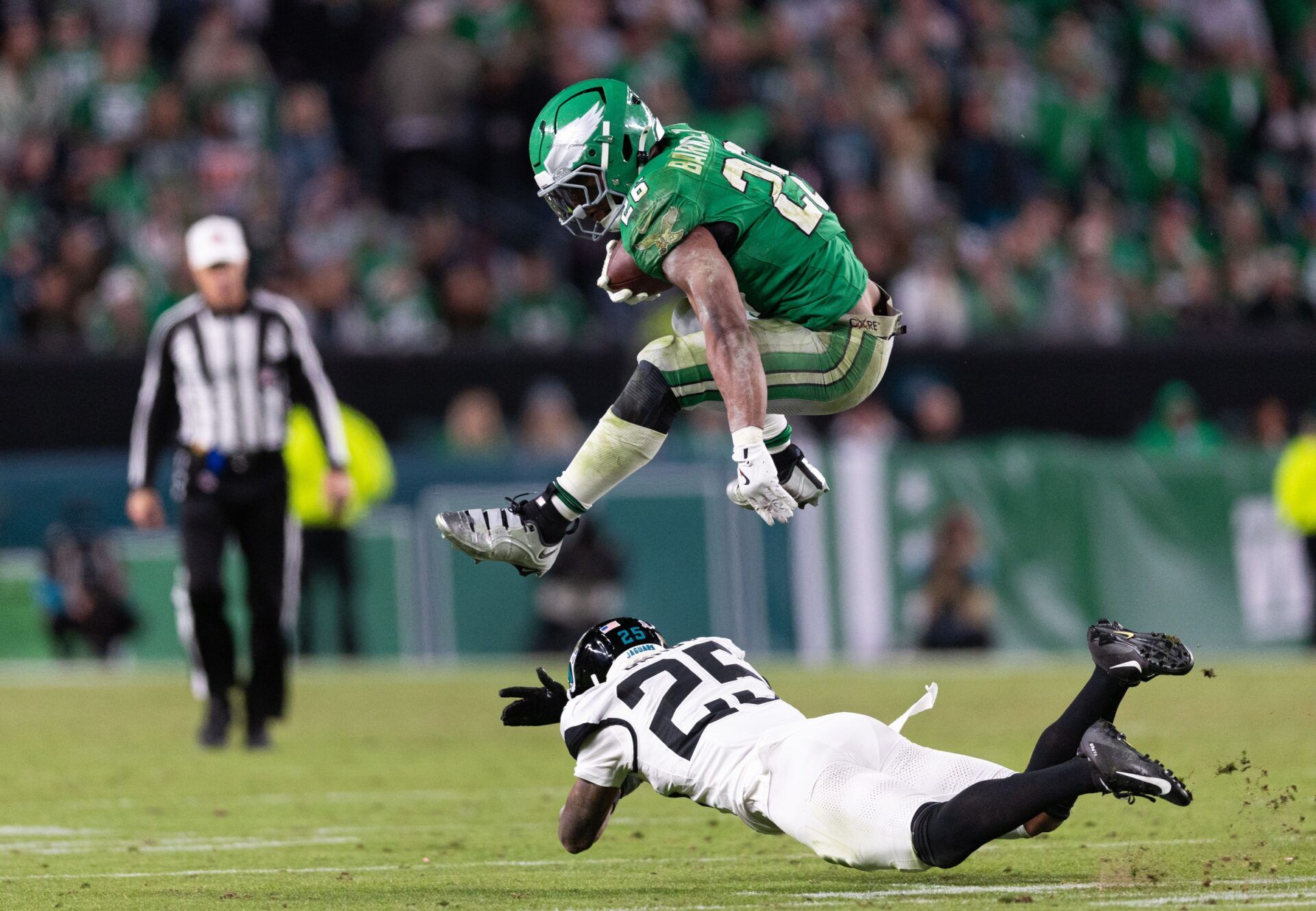 Philadelphia Eagles running back Saquon Barkley (26) leaps over Jacksonville Jaguars cornerback Ronald Darby (25) while running with the ball during the fourth quarter at Lincoln Financial Field.