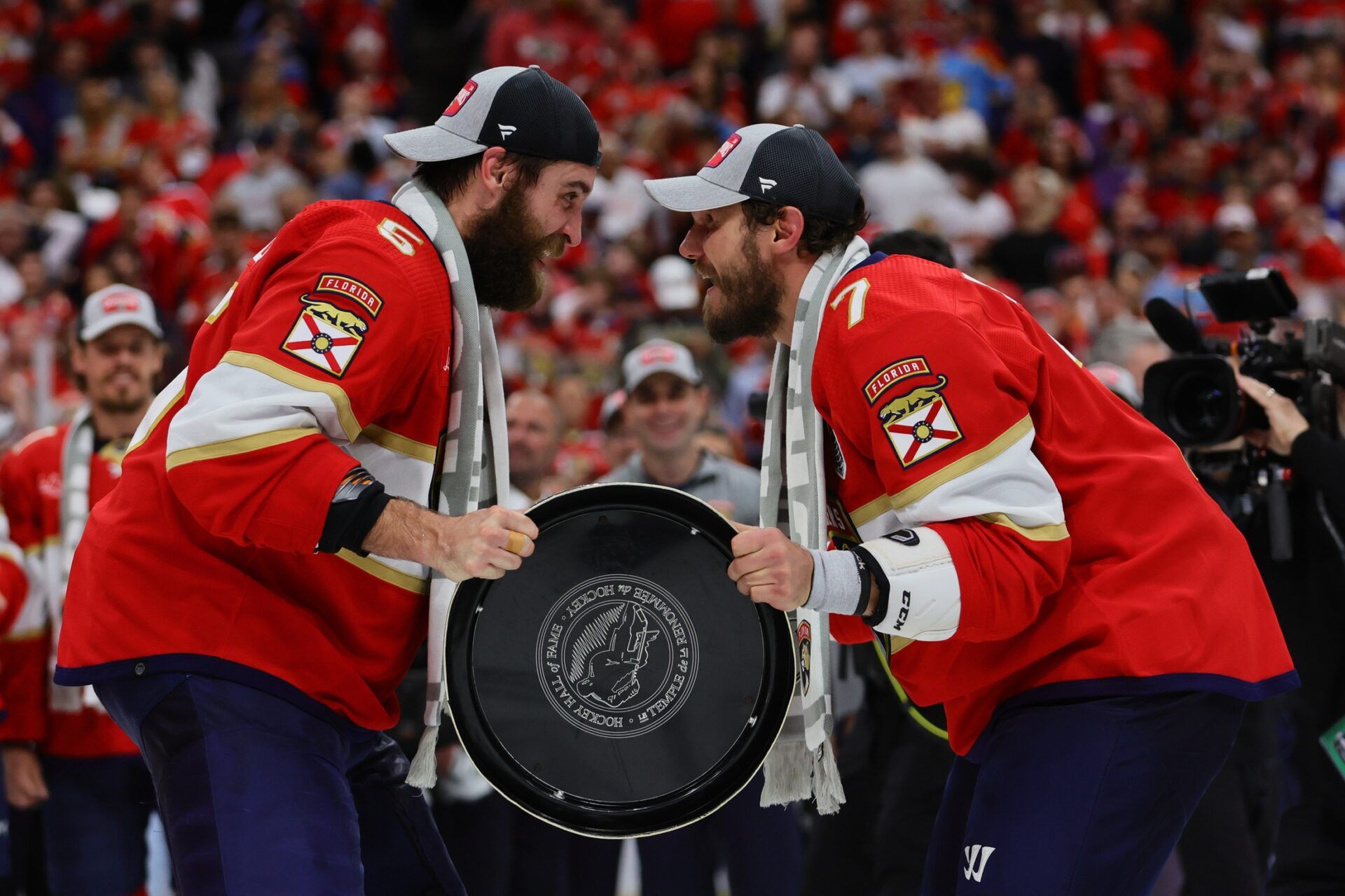 Florida Panthers defenseman Dmitry Kulikov (7) passes the Stanley Cup to Florida Panthers defenseman Aaron Ekblad (5) after defeating the Edmonton Oilers in game seven of the 2024 Stanley Cup Final at Amerant Bank Arena.