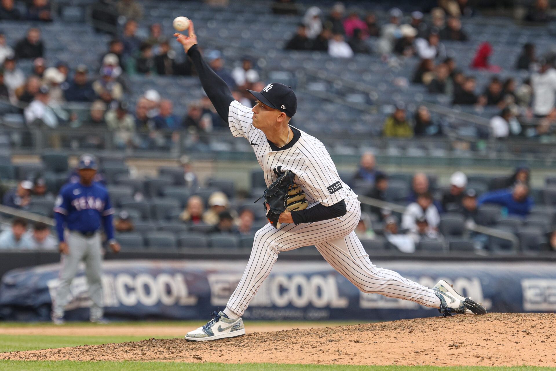 New York Yankees relief pitcher Luke Weaver (30) delivers a pitch during the ninth inning against the Texas Rangers at Yankee Stadium.